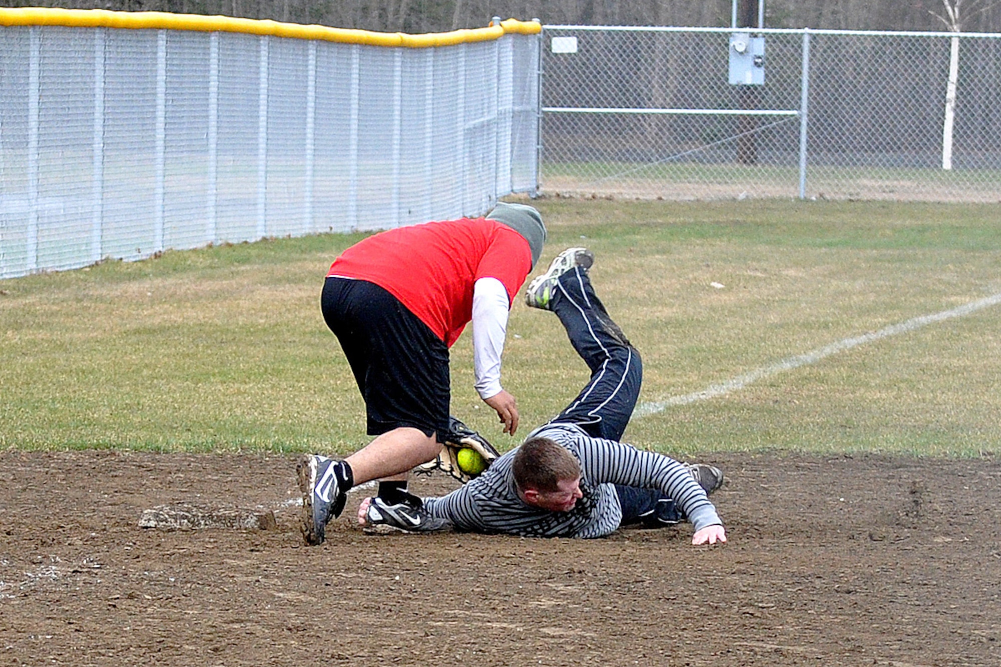 Marcos Juarez, 95th Chemical Company third baseman, tags Taylor Berry, 98th Maintenance Company, in the third-place game of the JBER-Richardson pre-season softball tournament Saturday at Buckner Physical Fitness Center's softball field 2. The 98th Maintenance team cruised past 95th Chemical Company, 20-10, to advance to the tournament championship. (U.S. Air Force photo/John Pennell)
