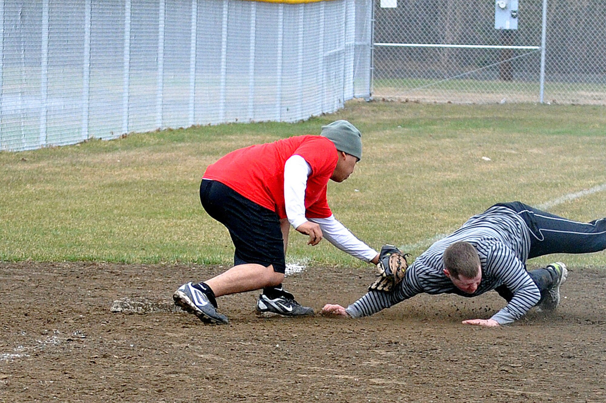 Marcos Juarez, 95th Chemical Company third baseman, tags Taylor Berry, 98th Maintenance Company, in the third-place game of the JBER-Richardson pre-season softball tournament Saturday at Buckner Physical Fitness Center's softball field 2. The 98th Maintenance team cruised past 95th Chemical Company, 20-10, to advance to the tournament championship. (U.S. Air Force photo/John Pennell)