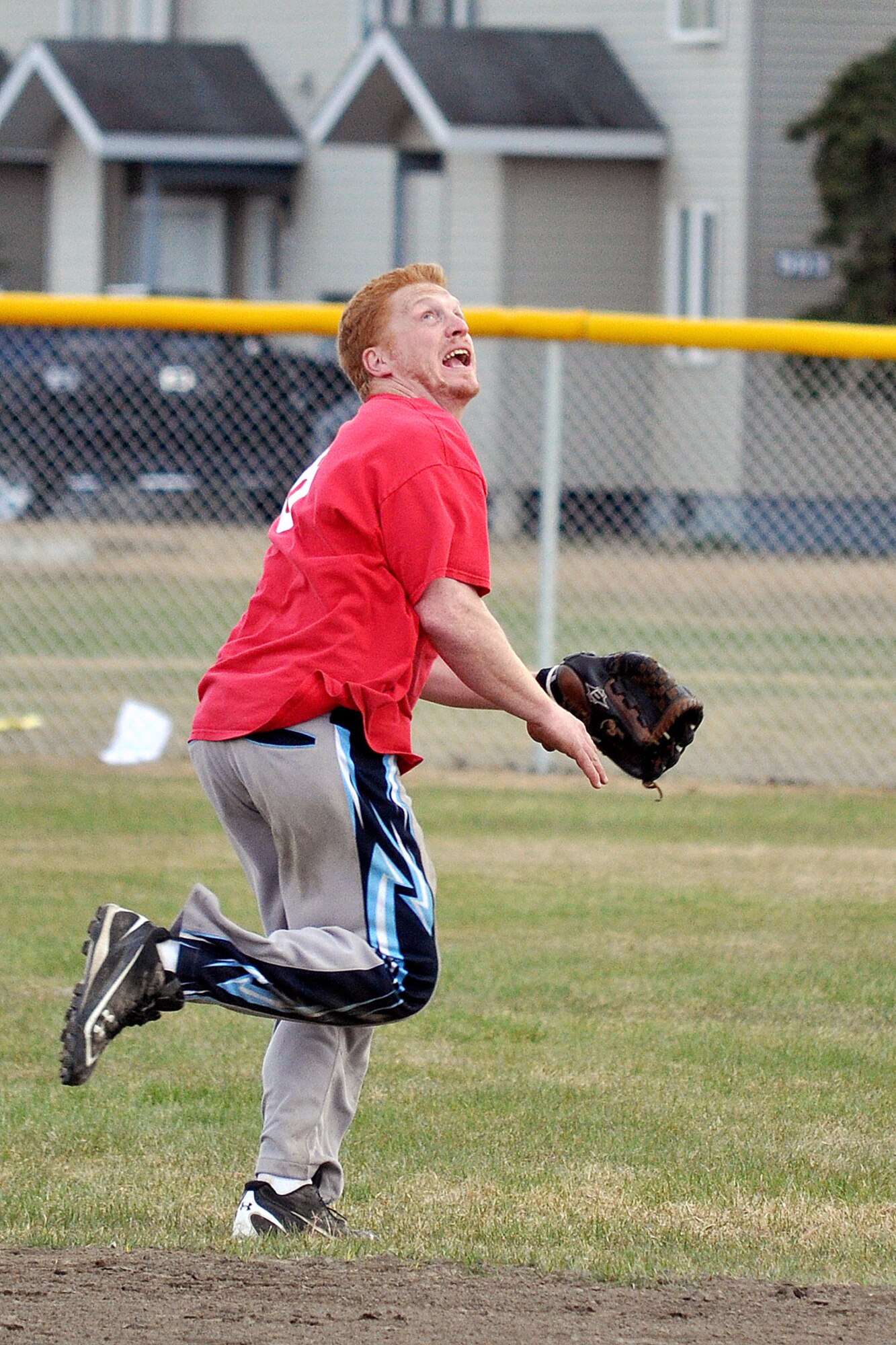 Dustin Baldwin, 98th Maintenance Company, chases a popup to end the second championship game of the JBER-Richardson pre-season softball tournament Saturday at Buckner Physical Fitness Center's softball field 3. The 98th Maintenance team stopped E Troop, 1st Squadron (Airborne), 40th Cavalry Regiment in consecutive games to win the tournament. (U.S. Air Force photo/John Pennell)