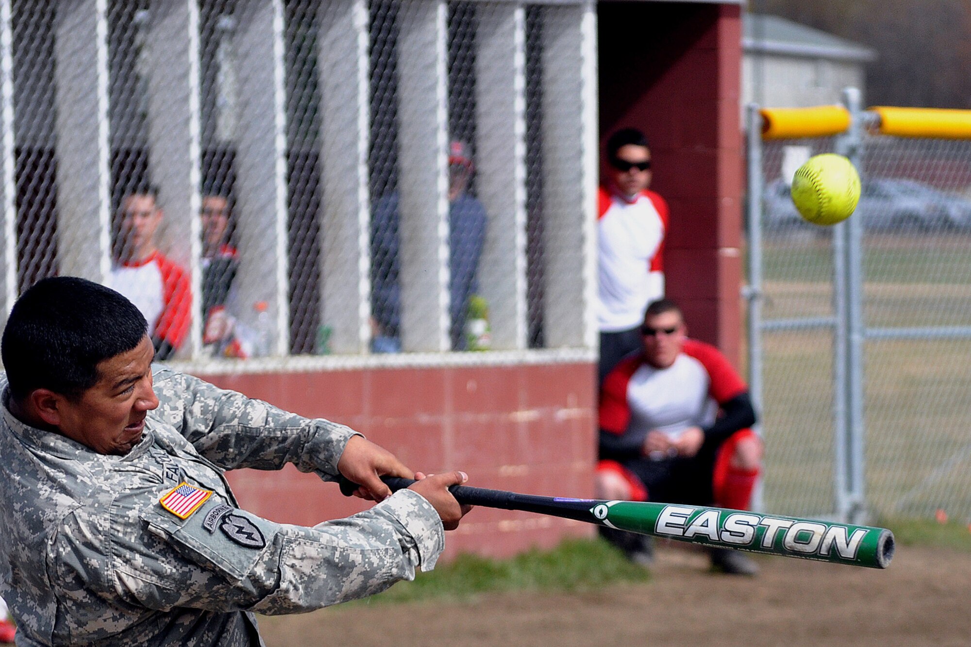 Raul Falciola, E Troop, 1st Squadron (Airborne) 40th Cavalry Regiment, drives the softball to left field against the 98th Maintenance Company in the JBER-Richardson pre-seaon softball tournament Saturday at Buckner Physical Fitness Center's softball field 2. The 98th Maintenance team stopped E Troop in consecutive games to win the tournament. (U.S. Air Force photo/John Pennell)
