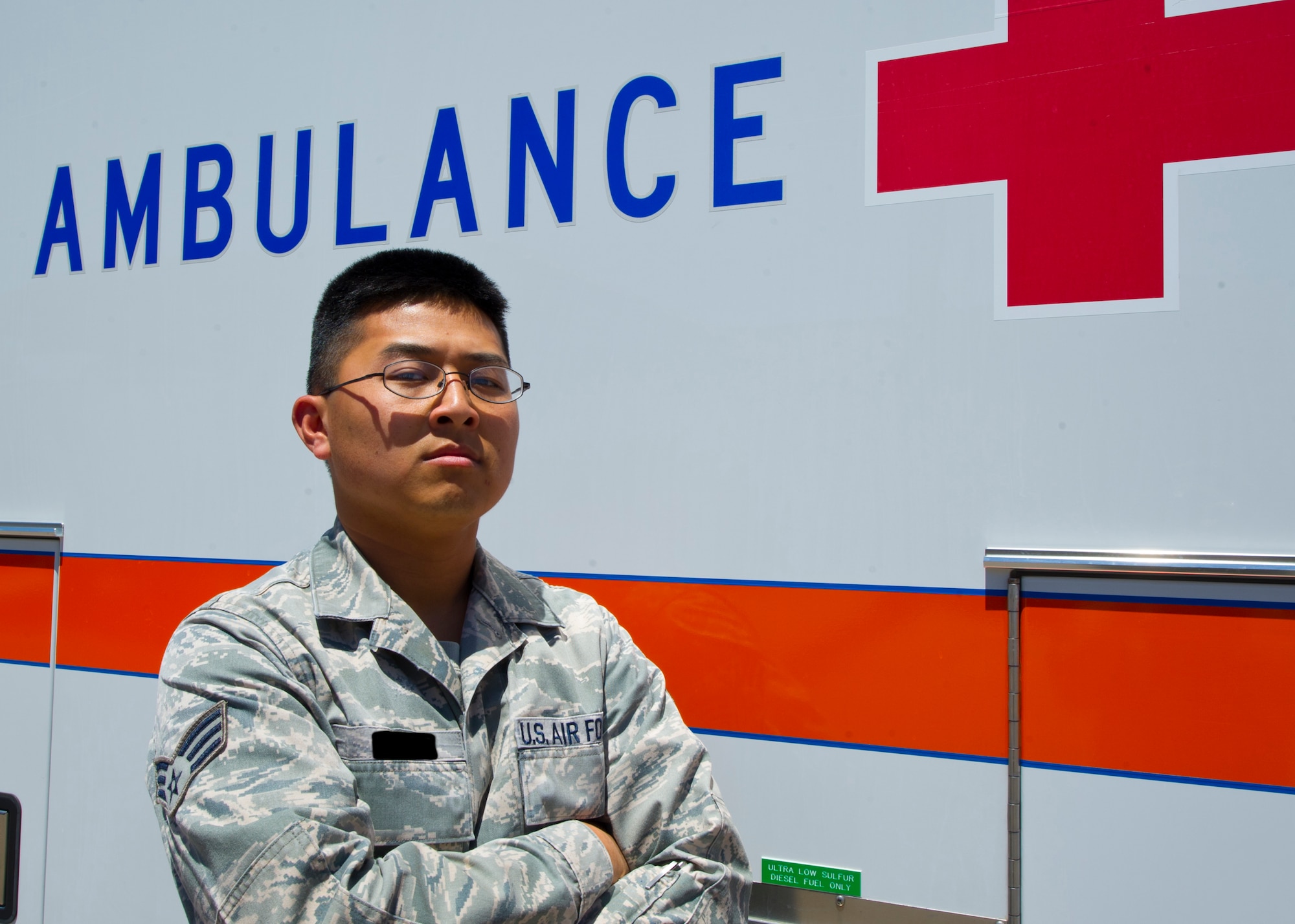 HOLLOMAN AIR FORCE BASE, N.M. -- Senior Airman Daniel (last name withheld), 6th Reconnaissance Squadron mission intelligence coordinator, poses in front of an ambulance May 16.  Daniel, a certified first responder, assisted an injured civilian after he was hit by a car at Nellis AFB, Nev. Daniel performed basic assessments on the victim to ensure the man did not further injure himself until emergency personnel arrived. (U.S. Air Force photo by Airman Leah Ferrante/Released)
