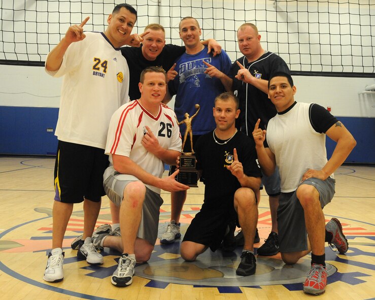 The 319th Security Forces Squadron volleyball team poses with the trophy after winning the intramural season championship match on May 5, 2012, at Grand Forks Air Force Base, N.D.  Security Forces beat the Spouse’s team to take the title.  (U.S. Air Force photo by Airman 1st Class Xavier Navarro)