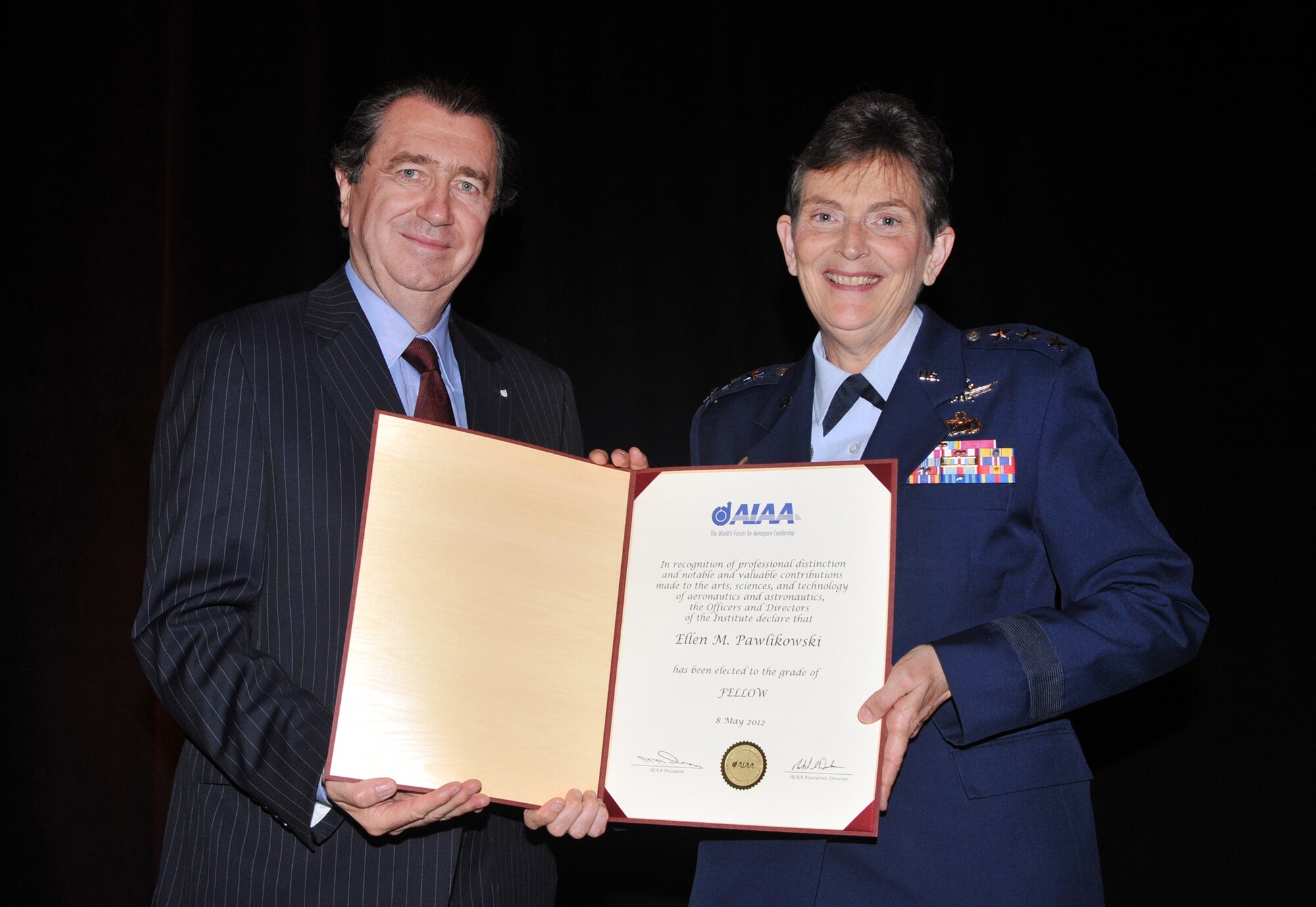 Space and Missile Systems Center Commander Lt. Gen. Ellen Pawlikowski
receives a certificate from American Institute of Aeronautics and
Astronautics President Brian Dailey inducting the general as an 2012 AIAA Fellow at a gala held in Washington D.C., May 8. The distinction of Fellow is conferred upon AIAA members who have made notable and valuable contributions to the arts, sciences, or aeronautics and astronautics technology.  There were 28 Fellows elected this year representing government, industry and academia. (Photo courtesy of AIAA)
