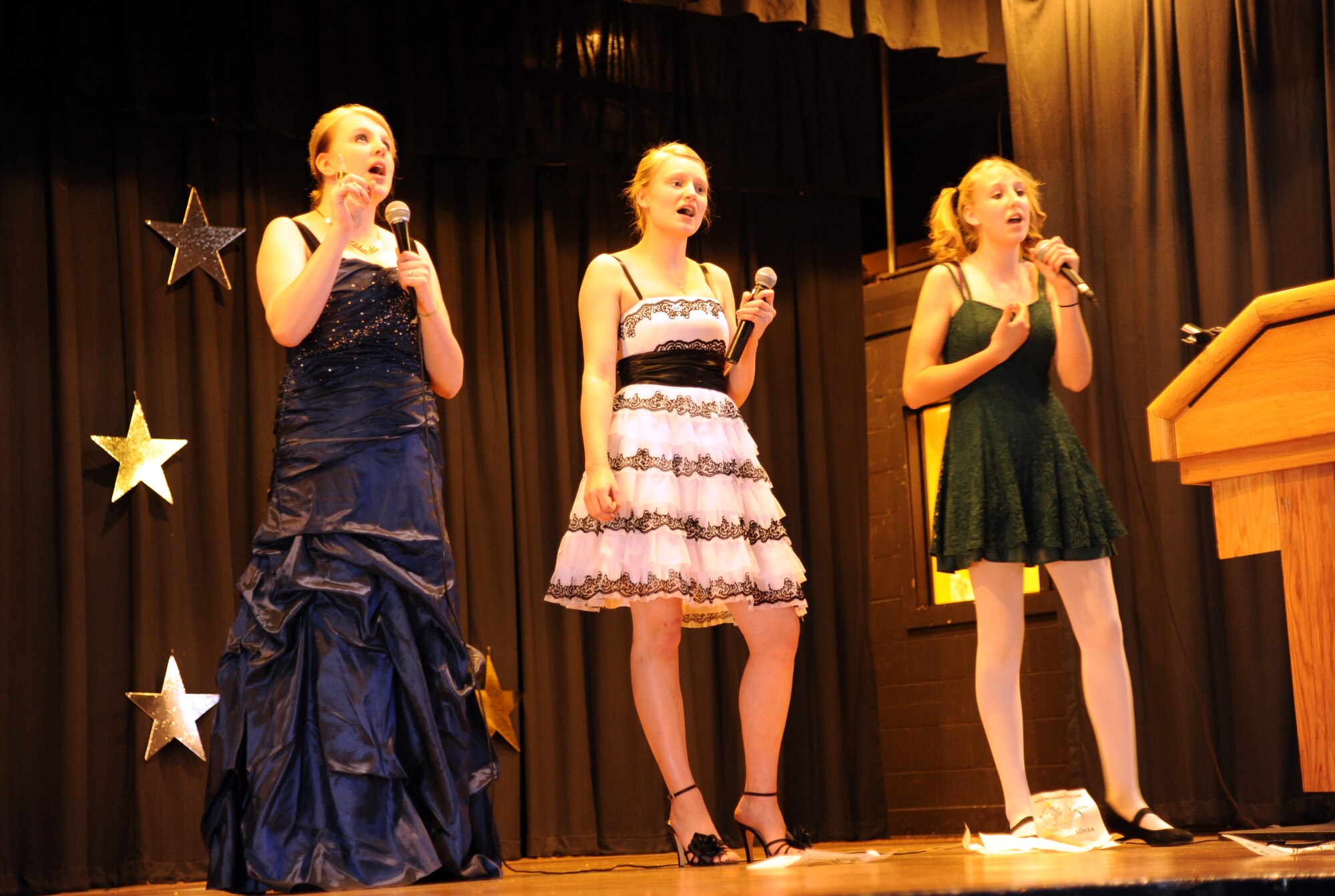 From left: Hailey Holmes, Kimmie Holmes and Paige Holmes – sisters – perform “I Know It’s Today” from “Shrek The Musical” during the UGT (You Got Talent) show  May 12, 2012, at Grand Forks Air Force Base, N.D.