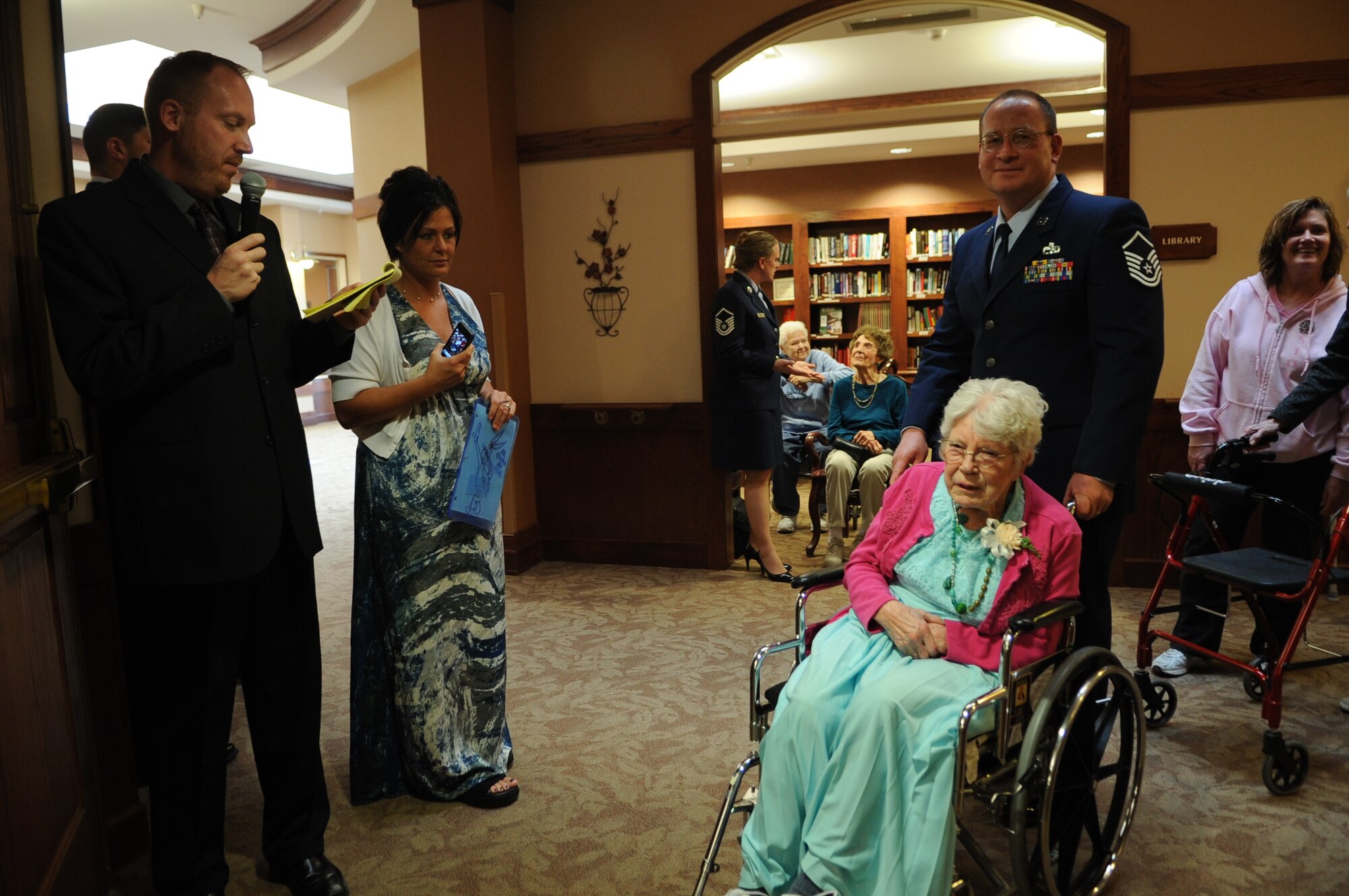 Master Sgt. Guy Ulshafer, member of the 319th Logistics Readiness Squadron, waits to be announced while escorting Charlotte Ohlheiser during the Senior Prom at Valley Memorial Homes-Woodside Village on April 27, 2012. Several Airmen from the base volunteered to serve as escorts at the event. (U.S. Air Force photo by Staff Sgt. Amanda N. Grabiec)