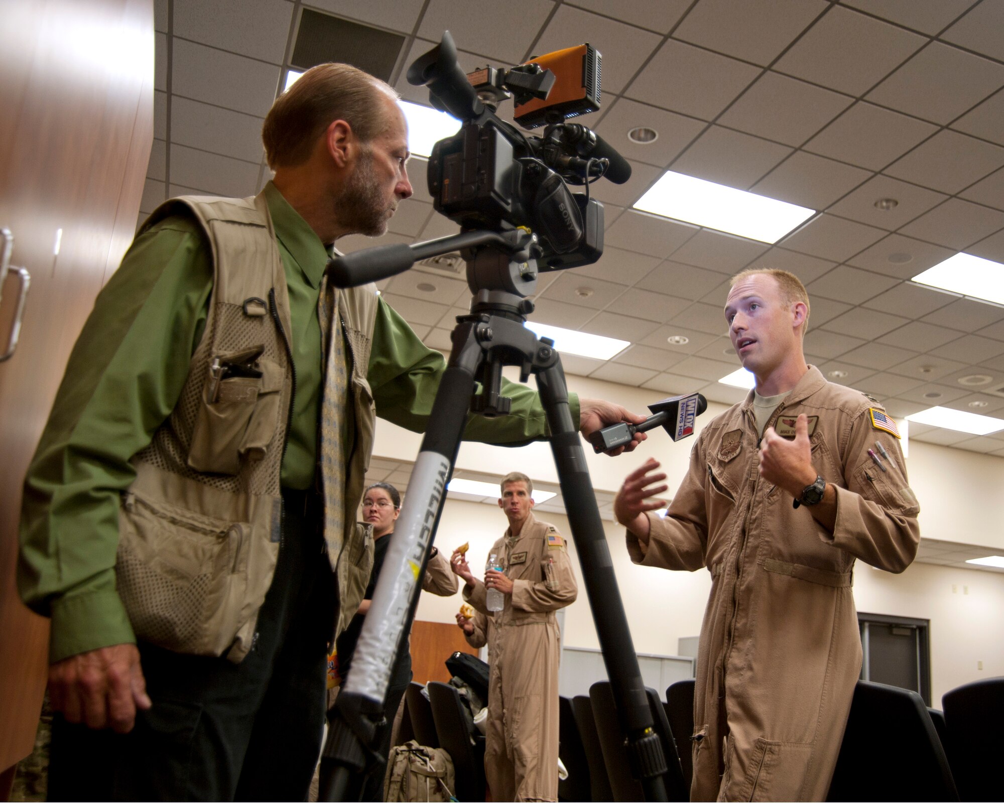 Capt. Mike Deprey, 345th Airlift Squadron pilot, takes a few moments to answer questions about his role in the squadron's upcoming deployment to Southwest Asia.(U.S. Air Force photo by Maj. Heather Newcomb)
