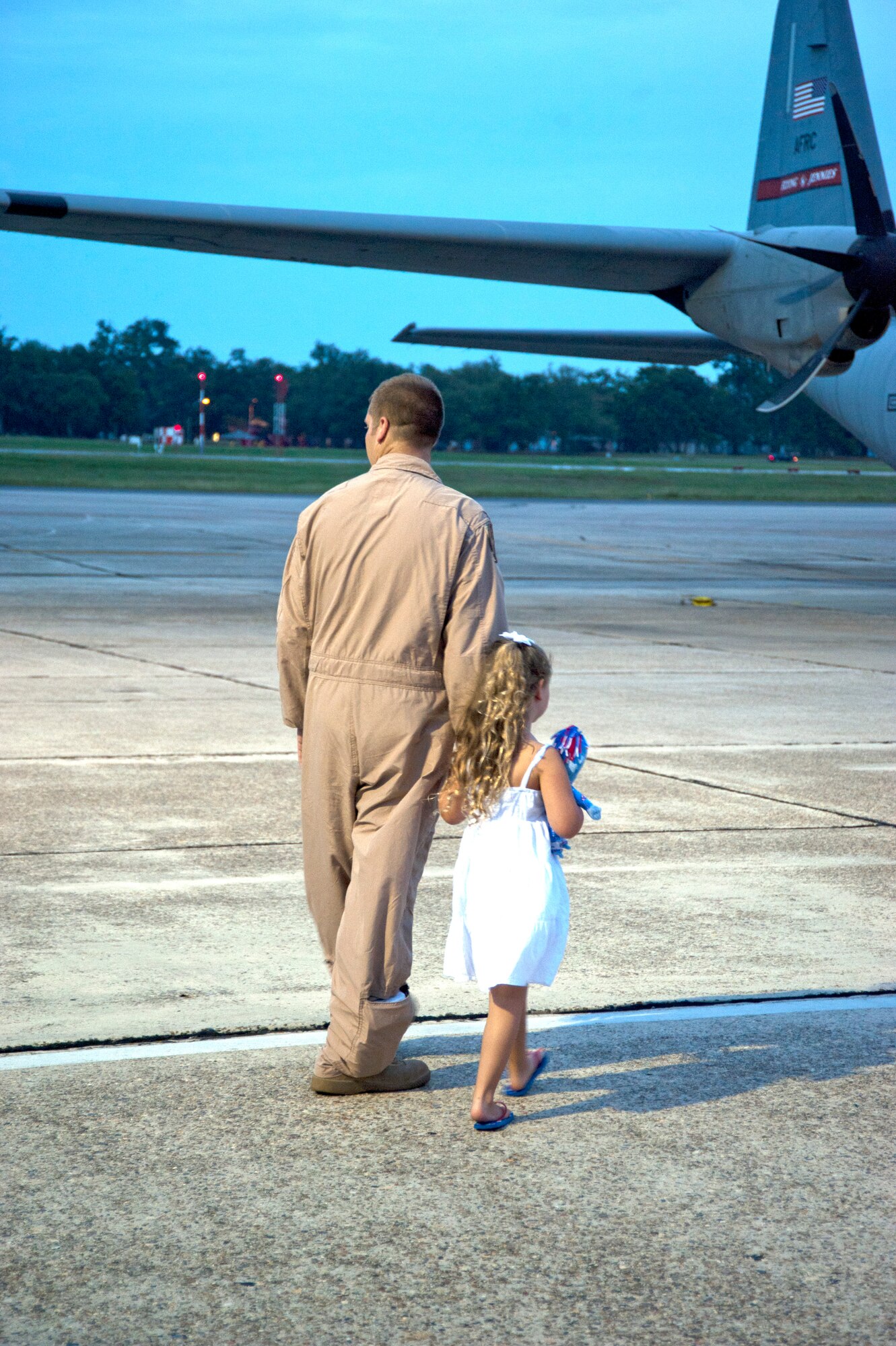 Staff Sgt. Andrew Vogel, 345th Airlift Squadron, holds his daughter Lilly's hand before he leaves for deployment to Southwest Asia. (U.S. Air Force photo by Maj. Heather Newcomb)