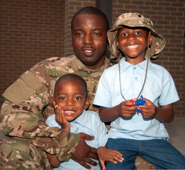 Senior Airman Deonte Spann, 345th Maintenance, poses for a quick photo with his two oldest sons, Deon and Catrell, before deploying to Southwest Asia. (U.S. Air Force photo by Maj. Heather Newcomb)