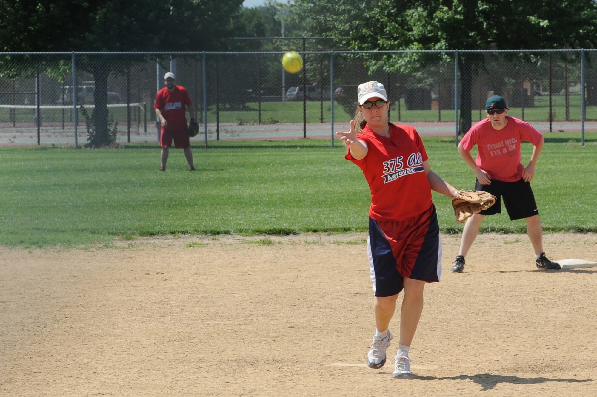 Capt. Carla Wiese, 375th Aeromedical Evacuation Squadron mission planning officer in charge, pitches to members of the 375th Security Forces Squadron during a softball tournament held by SFS for National Police Week at Scott's softball field , Ill, May 16, 2012. . In October 1969 President Kennedy signed a joint resolution declaring May 15th Peace Officers Memorial Day and the week that the 15th fell National Police Week.  During the week flags are flown at half mass in honor of those who have lost their lives in the line of duty. (U.S. Air Force photo/Staff Sgt. Teresa M. Jennings)