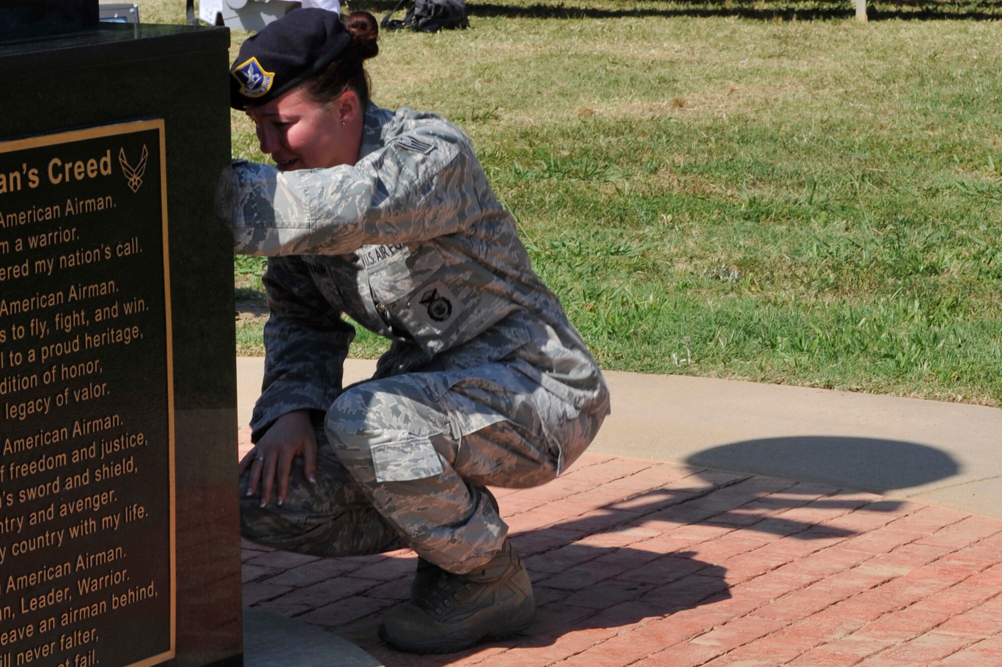Staff Sgt. Leah Kassebaum, a 19th Security Forces Squadron flight chief, takes a moment to reflect on the loss of Staff Sgt. John Self, a fallen 19th SFS member who paid the ultimate sacrifice while supporting combat operations in Southwest Asia, following the Global War on Terrorism Wreath Laying Ceremony May 17, 2012, at Little Rock Air Force Base, Ark. The 19th SFS squadron honored the memory of their fallen comrade during National Police Week, an annual week honoring the efforts of first responders. (U.S. Air Force photo by Airman 1st Class Rusty Frank)