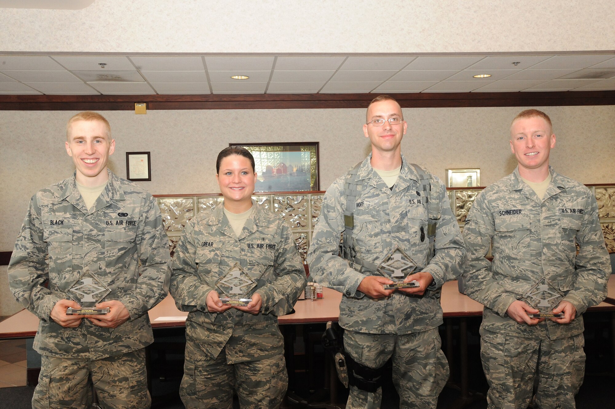 May’s Diamond Sharp Award recipients are (from left to right) Airman 1st Paul Black, 319th Logistics Readiness Squadron; Airman 1st Class Kaitlynn Grear, 319th Medical Operations Squadron; Airman 1st Class Brian Hoff, 319th Security Forces Squadron; and Airman 1st Class Jim Schneider. (U.S. Air Force photo by Airman 1st Class Xavier Navarro)
