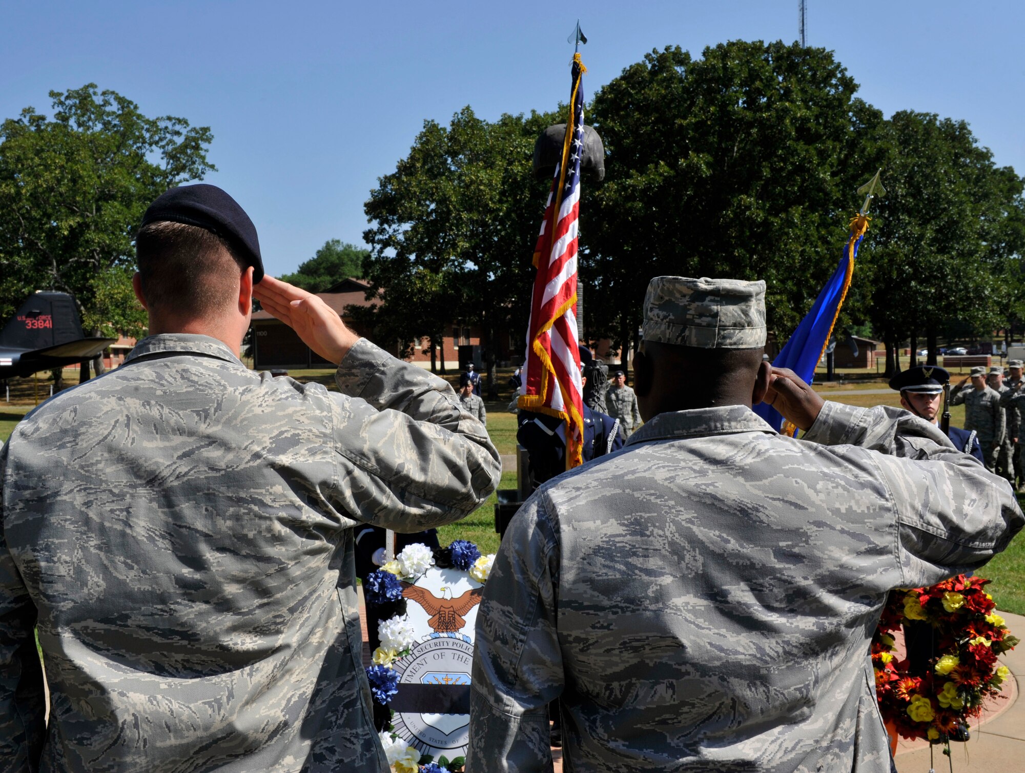 Maj. Peter Lex, 19th Security Forces Squadron commander and Lt. Col. Steven Coy, 19th Logistics Readiness Squadron commander,salute for the singing of the National Anthem during the Global War on Terrorism Wreath Laying Ceremony May 17, 2012, at Little Rock Air Force Base, Ark. Lex and Coy laid wreaths to honor the members that paid the ultimate sacrifice from their squadrons. (U.S. Air Force photo by Airman 1st Class Rusty Frank)