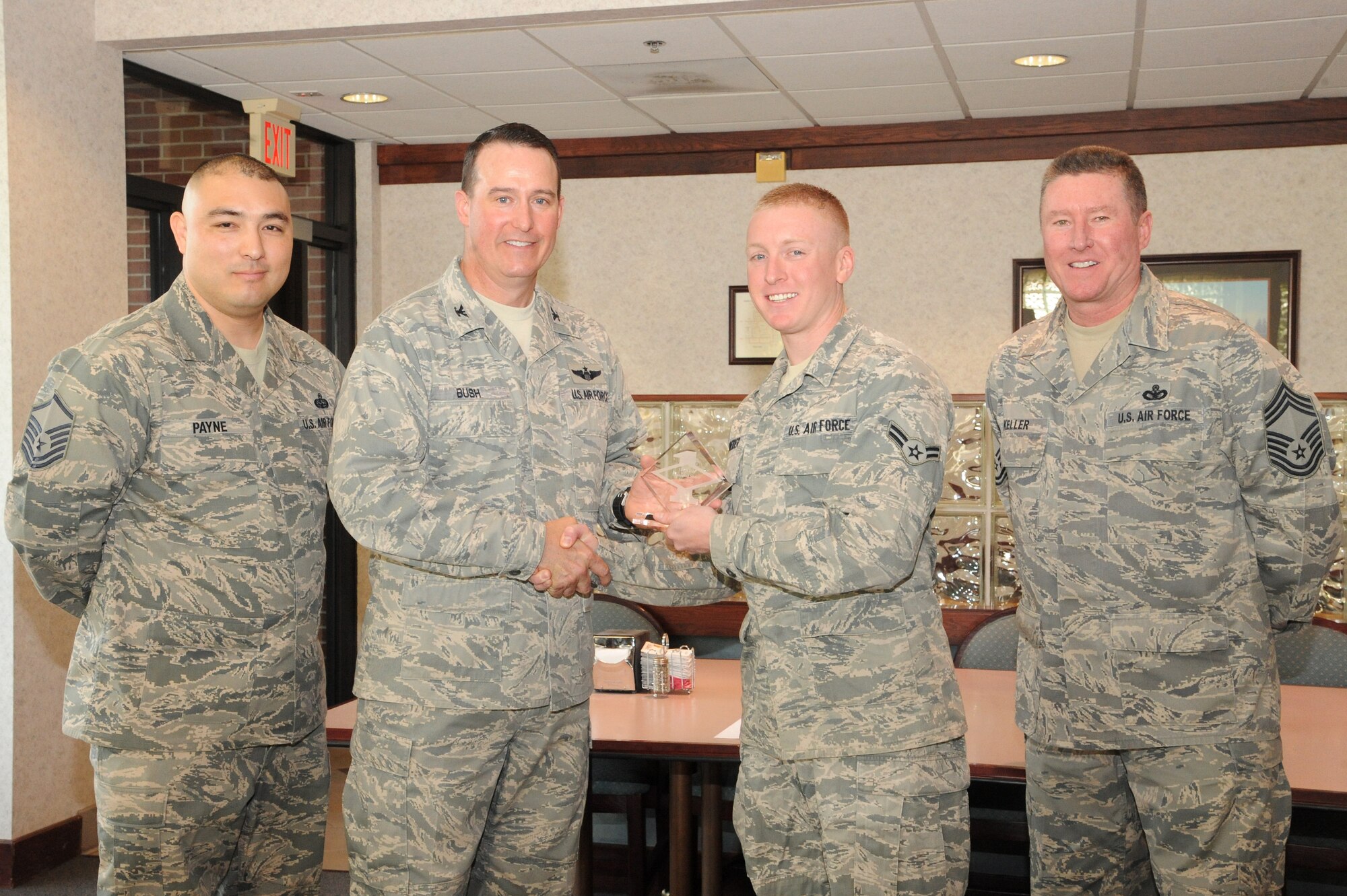 Col. Tim Bush, 319th Air Base Wing commander, presents Airman 1st Class Jim Schneider with a Diamond Sharp Award May 17, 2012, on Grand Forks Air Force Base, N.D., accompanied by Chief Master Sgt. Ed Keller, 319th Mission Support Group superintendent, and Master Sgt. John Payne. The Diamond Sharp Award is given to Airmen who epitomize service before self and strive for excellence at work and off duty.  (U.S. Air Force photo by Airman 1st Class Xavier Navarro)