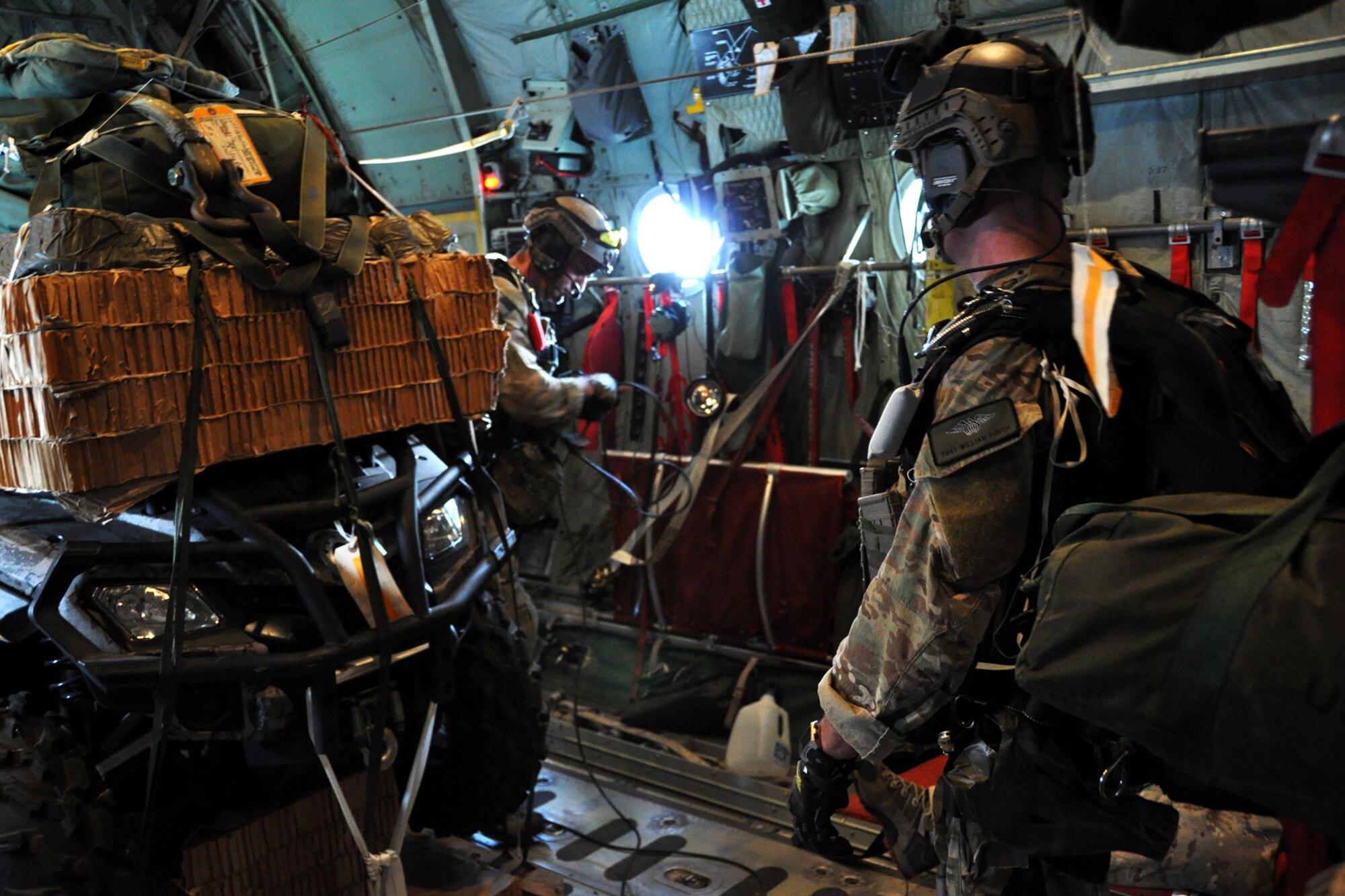 Pararescuemen from the 920th Rescue Wing, Patrick Air Force Base, Fla., prepare for a combat search and rescue (CSAR) mission in support of the Patriot Saint exercise, Barksdale Air Force Base, La., May 16, 2012. The mission consisted of off-loading two pallets of equipment by parachute from an HC-130 King, followed by the Pararescuemen parachuting from the aircraft to perform CSAR for two personnel, extracting them from the combat area. (U.S. Air Force photo by Master Sgt. Joshua Woods/Released)