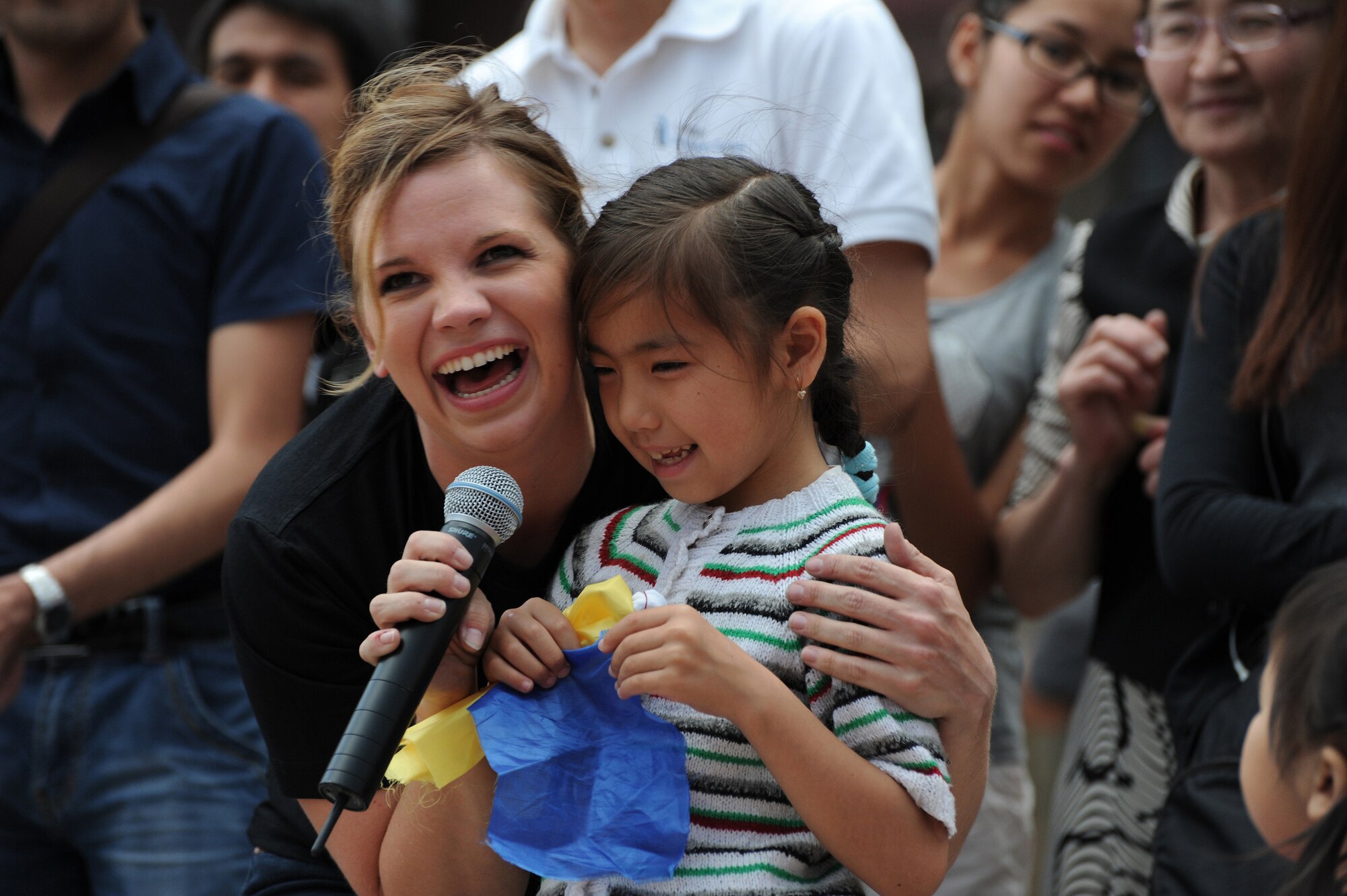 Airman 1st Class Melissa Rager sings with 7-year-old Ilena during an outdoor concert in Ala Too Square, Bishkek, Kyrgyzstan, May 16, 2012. Rager is a vocalist with the U.S. Air Forces Central Band "Night Wing" deployed from Offutt Air Force Base, Neb. The audience of more than 2,000 people included a vast range of ages from elders, to teenagers, to toddlers with their parents. (U.S. Air Force photo/Master Sgt. Tracy L. DeMarco)