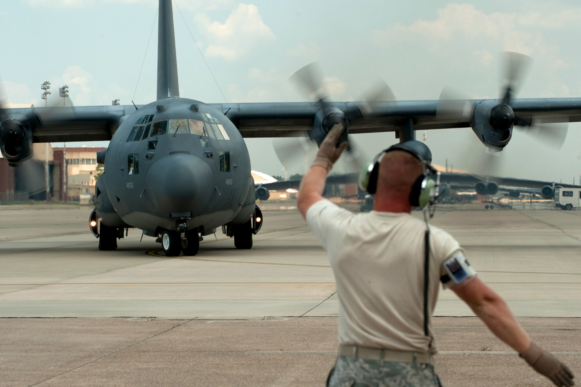 U.S. Air Force Staff Sgt. James Bedgood, 920th Aircraft Maintenance Squadron crew chief, marshals an HC-130 out of its parking spot for a mission in support of the Patriot Saint exercise, Barksdale Air Force Base, La., May 16, 2012. The exercise conducted and led by Air Force Reserve Command's 10th Air Force, presents real-time, realistic combat search and rescue missions. (U.S. Air Force photo by Master Sgt. Greg Steele/Released)