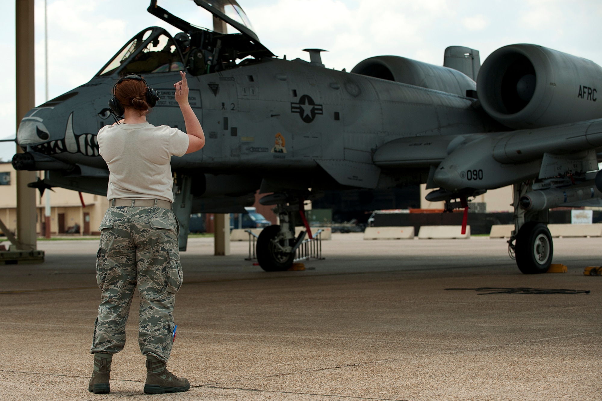 U.S. Air Force Senior Airman Kari Ferolito, 917th Aircraft Maintenance Squadron crew chief, marshals an A-10 Thunderbolt II from its parking spot for a sortie in support of the Patriot Saint exercise, Barksdale Air Force Base, La., May 16, 2012. The A-10 is assigned to the 47th Fighter Squadron, 917th Fighter Group, and conducted combat search and rescue during the exercise. (U.S. Air Force photo by Master Sgt. Greg Steele/Released)
