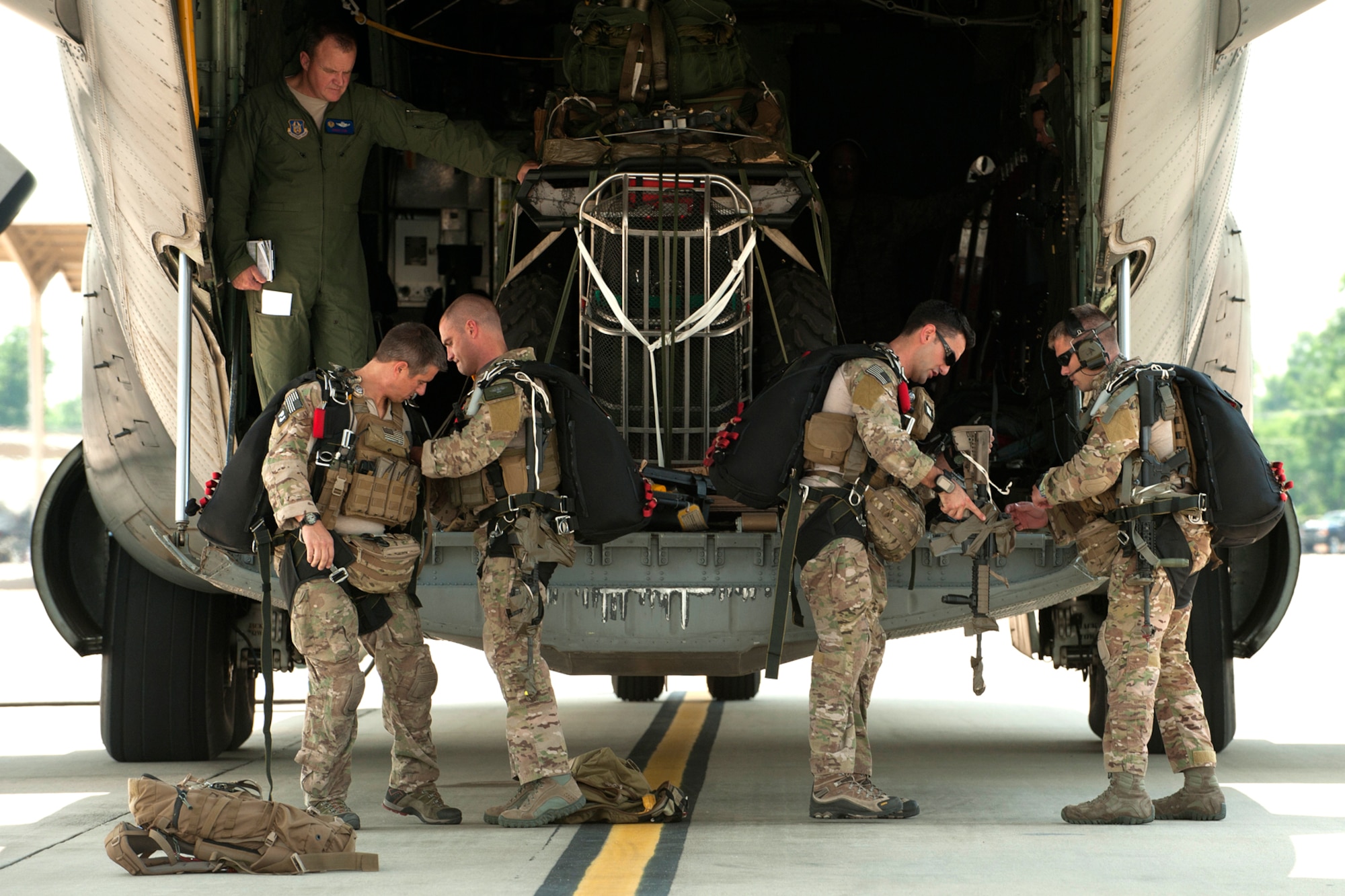 Pararescuemen from the 920th Rescue Wing, Patrick Air Force Base, Fla., prepare for a combat search and rescue (CSAR) mission in support of the Patriot Saint exercise, Barksdale Air Force Base, La., May 16, 2012. The mission consisted of an equipment air-drop by an HC-130 King at a designated area on Fort Polk, La., followed immediately by the Pararescuemen parachuting from the aircraft to perform search and rescue operations. (U.S. Air Force photo by Master Sgt. Greg Steele/Released)