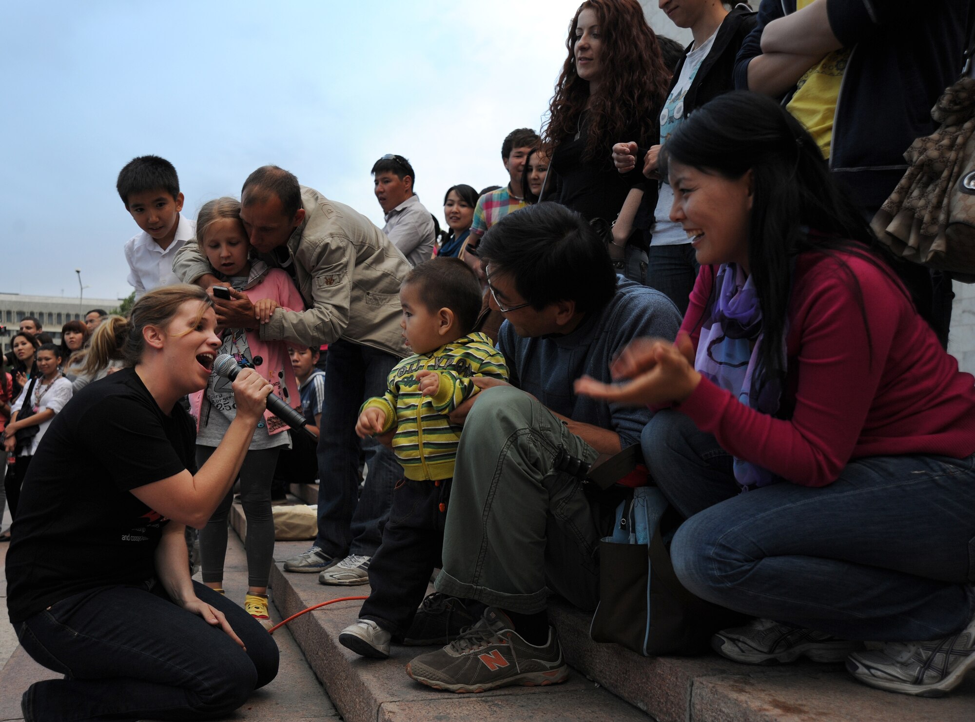 Airman 1st Class Melissa Rager, a vocalist with the U.S. Air Forces Central Band "Night Wing," sings to 14-month-old Bakai and his parents Talant and Aiperi during a concert at the Kyrgyz State Museum of History, Bishkek, Kyrgyzstan, May 16, 2012. This is Bakai's second Air Force band concert in his life. "He loves American music," Talant smiled. (U.S. Air Force photo/Master Sgt. Tracy L. DeMarco)