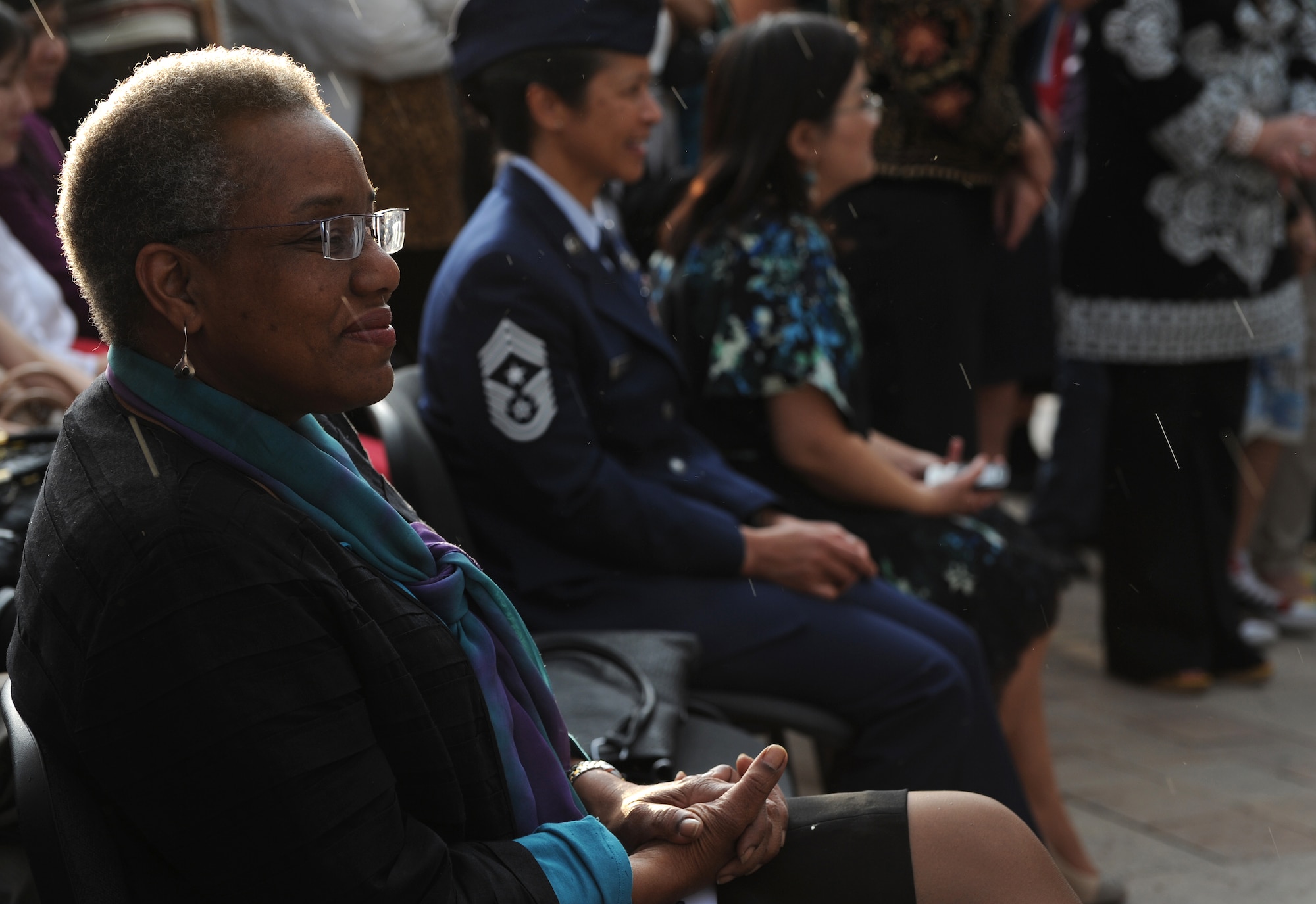 Smiling through the rain, U.S. Ambassador to the Kyrgyz Republic, Pamela Spratlen, listens to Col. James Jacobson's opening remarks at the "Museum Night" event held in Ala Too Square, Bishkek, Kyrgyzstan, May 16, 2012. Jacobson, 376th Air Expeditionary Wing commander, introduced the U.S. Air Forces Central Band "Night Wing" before their performance. "The Band Night Wing being here tonight is a way for us to continue to be a good neighbor with you as you are gracious enough to host the Transit Center at the Manas International Airport. We work together most days to make the world a safer place, let's work together tonight to unite the two cultures via music and have a great night," he said. (U.S. Air Force photo/Master Sgt. Tracy L. DeMarco)