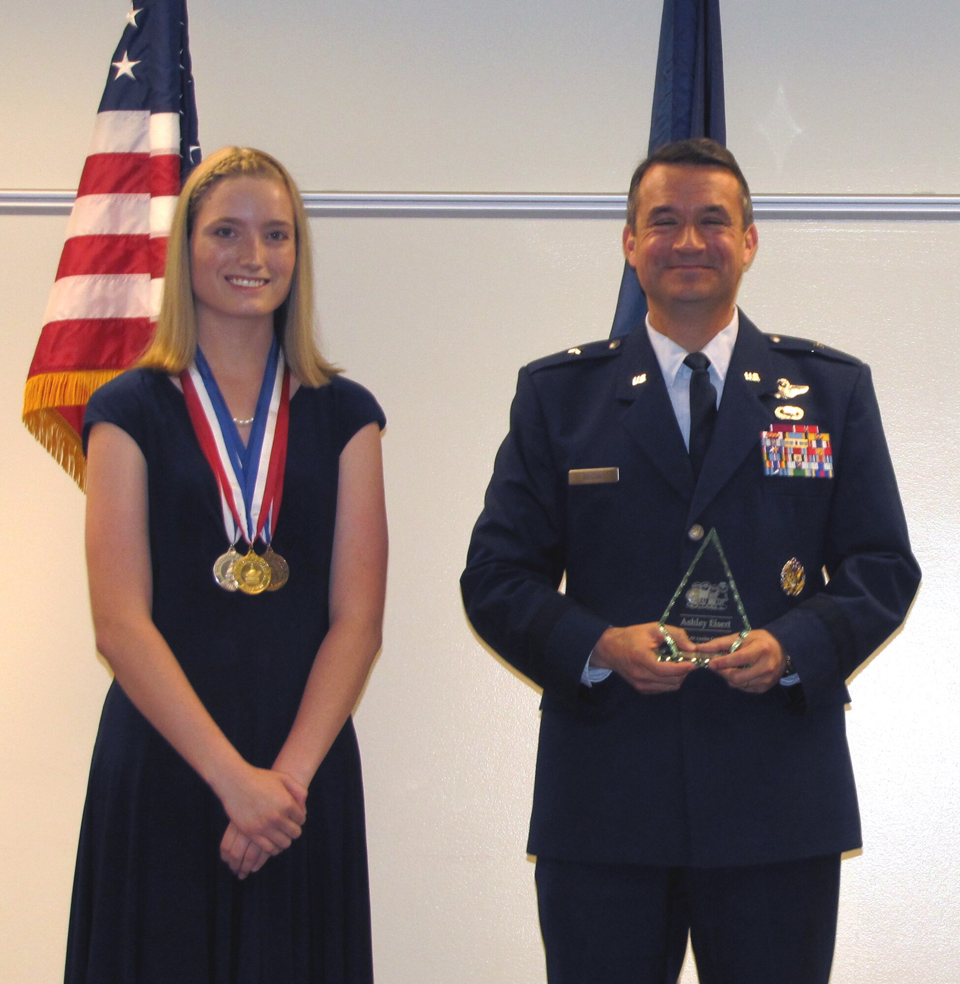U.S. Air Force Brig. Gen. Donald Bacon, 55th Wing commander, presents Ashley Eisert with the 2012 Air Combat Command youth of the year award.  Eisert was previously awarded the bronze, silver and gold congressional medals.