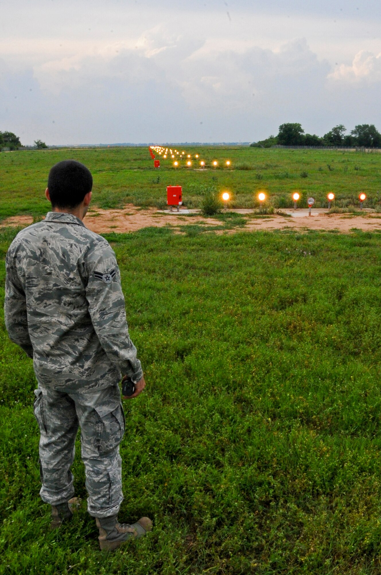 Airman 1st Class Mario Carfagno III, 2nd Operations Support Squadron airfield manager, ensures the runway approach lights illuminate on Barksdale Air Force Base, La., May. 15. Approach lights are a critical tool aircrew members use when landing aircraft during hours of darkness or low visibility. Without the lights, aircrew members could potentially have a difficult time locating the runway. (U.S. Air Force photo/Airman 1st Class Micaiah Anthony)(RELEASED)