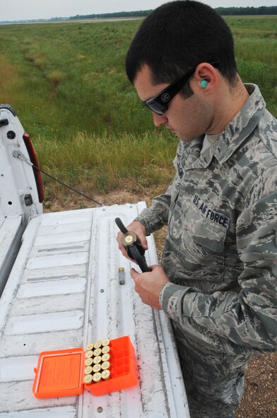 Airman 1st Class Mario Carfagno III, 2nd Operations Support Squadron airfield management, loads a 12-gauge pyrotechnics pistol with a shell cracker on Barksdale Air Force Base, La., May 15. The 12-gauge pistol uses a small pyrotechnic charge to scare birds away from the flightline to prevent aircraft mishaps. (U.S. Air Force photo/Airman 1st Class Micaiah Anthony)(RELEASED)