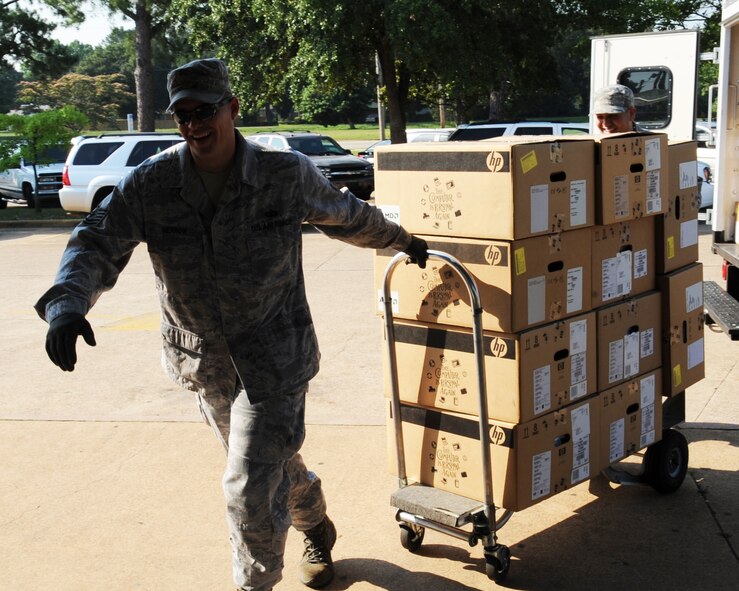 Tech. Sgt. Ray Merrow, 2nd Communications Squadron asset management office NCO-in-charge, delivers computers to Rusheon Middle School in Bossier City, La., May 17. The 2 CS donated a total of 53 computers to local schools. (U.S. Air Force photo/Senior Airman Sean Martin)(RELEASED)