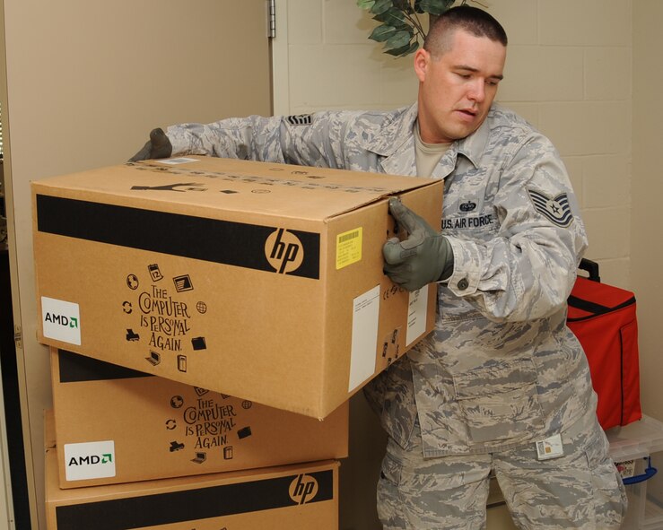 Tech. Sgt. Ray Merrow, 2nd Communications Squadron asset management office NCO-in-charge, stacks computers at Rusheon Middle School in Bossier City, La., May 17. The 2 CS gathered computers that were never connected to the base network and donated them to various schools in the area. The schools included Waller Middle School, Bossier High School and R.V. Kerr Middle School (U.S. Air Force photo/Senior Airman Sean Martin)(RELEASED)