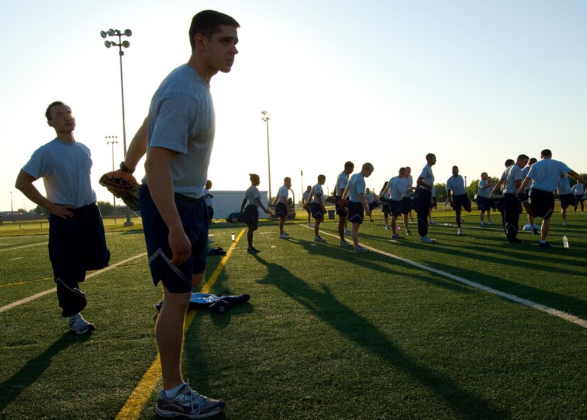 Senior Airmen Julian Alberni, 7th Civil Engineer Squadron, stretches during a physical training session May 16, 2012, at Dyess Air Force Base, Texas. Of all the Dyess airmen to take a physical assessment this year, Alberni was the top overall performer. Alberni performed 67 push-ups and 60 sit-ups during his last physical assessment, scores that gave him the maximum points for those portions of the test. But where he really excelled was his run. He ran his 1.5 miles in 8:16. (U.S. Air Force photo by Airman 1st Class Damon Kasberg/Released)