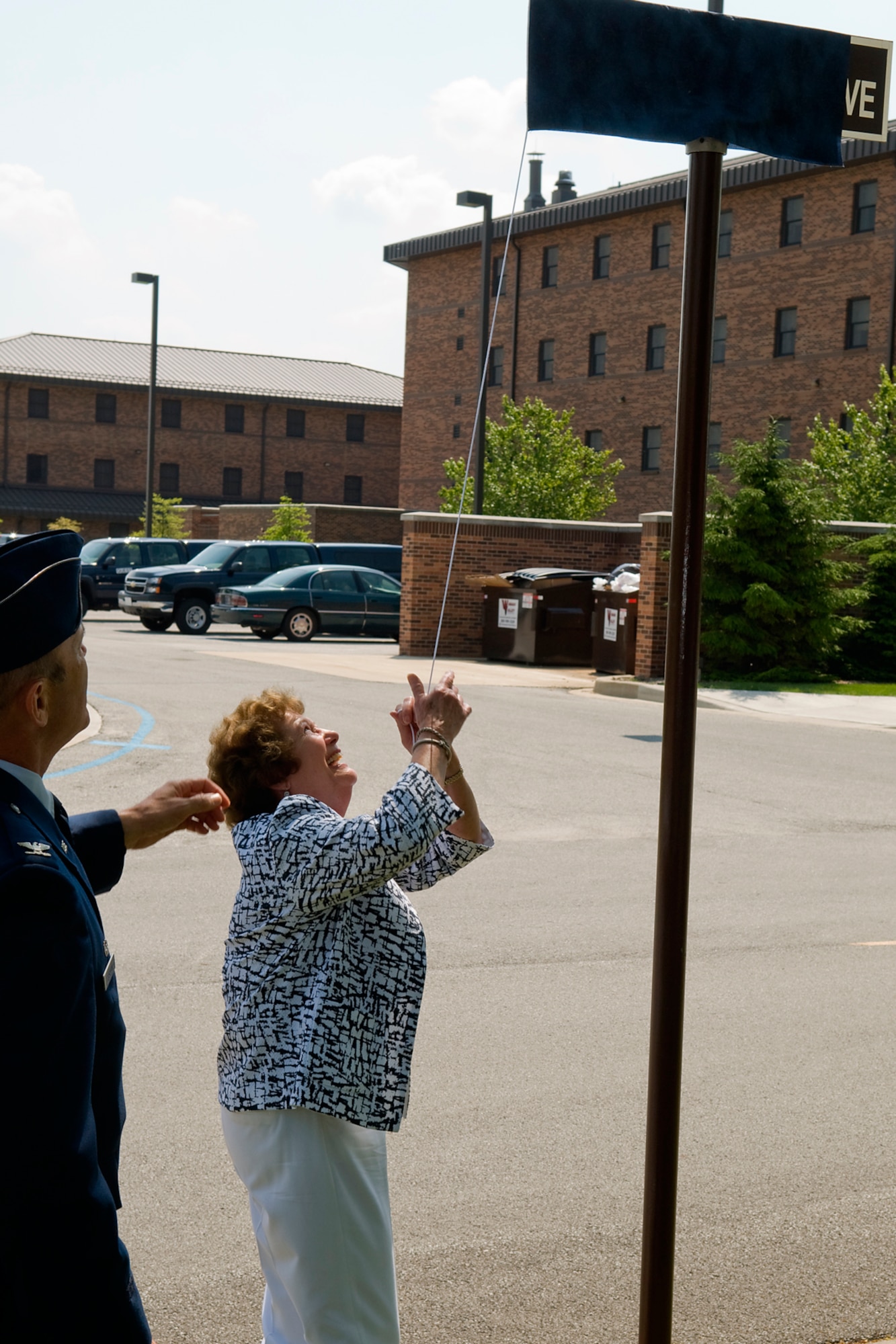 GRISSOM AIR RESERVE BASE, Ind. -- Phyllis Evens, wife of the late Col. (Dr.) Marvin Evens, unveils a Doc Evens Avenue sign during a special ceremony here May 14. Evens was a 930th Medical Group commander and A-10 pilot who lost his life when his A-10 crashed during a training mission near Grissom in 1992. (U.S. Air Force photo/Tech. Sgt. Mark R. W. Orders-Woempner)
