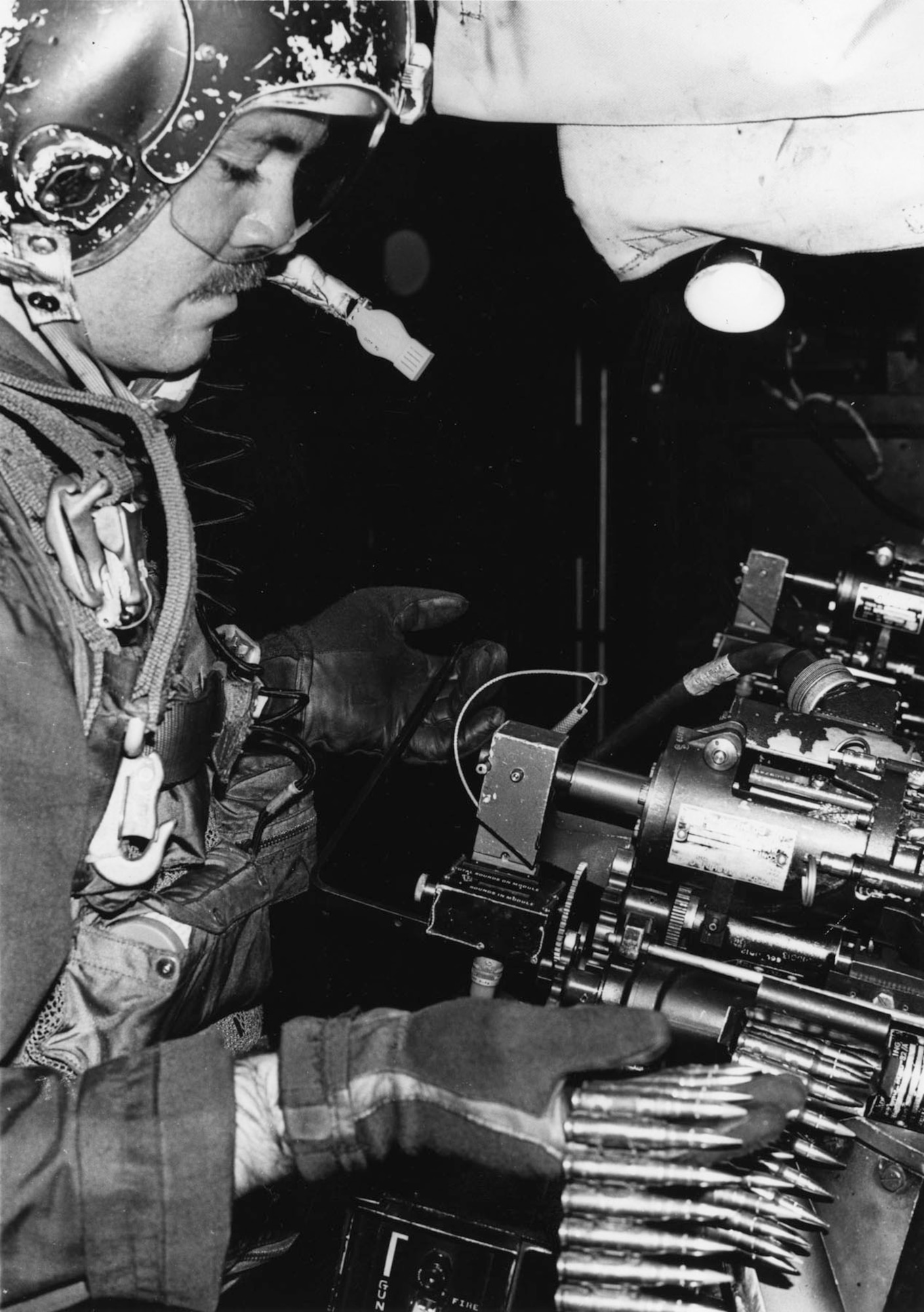 Staff Sgt. Harry R. Watters, AC-119 gunner, loads 1,500 rounds into a 7.62mm minigun. (U.S. Air Force photo)