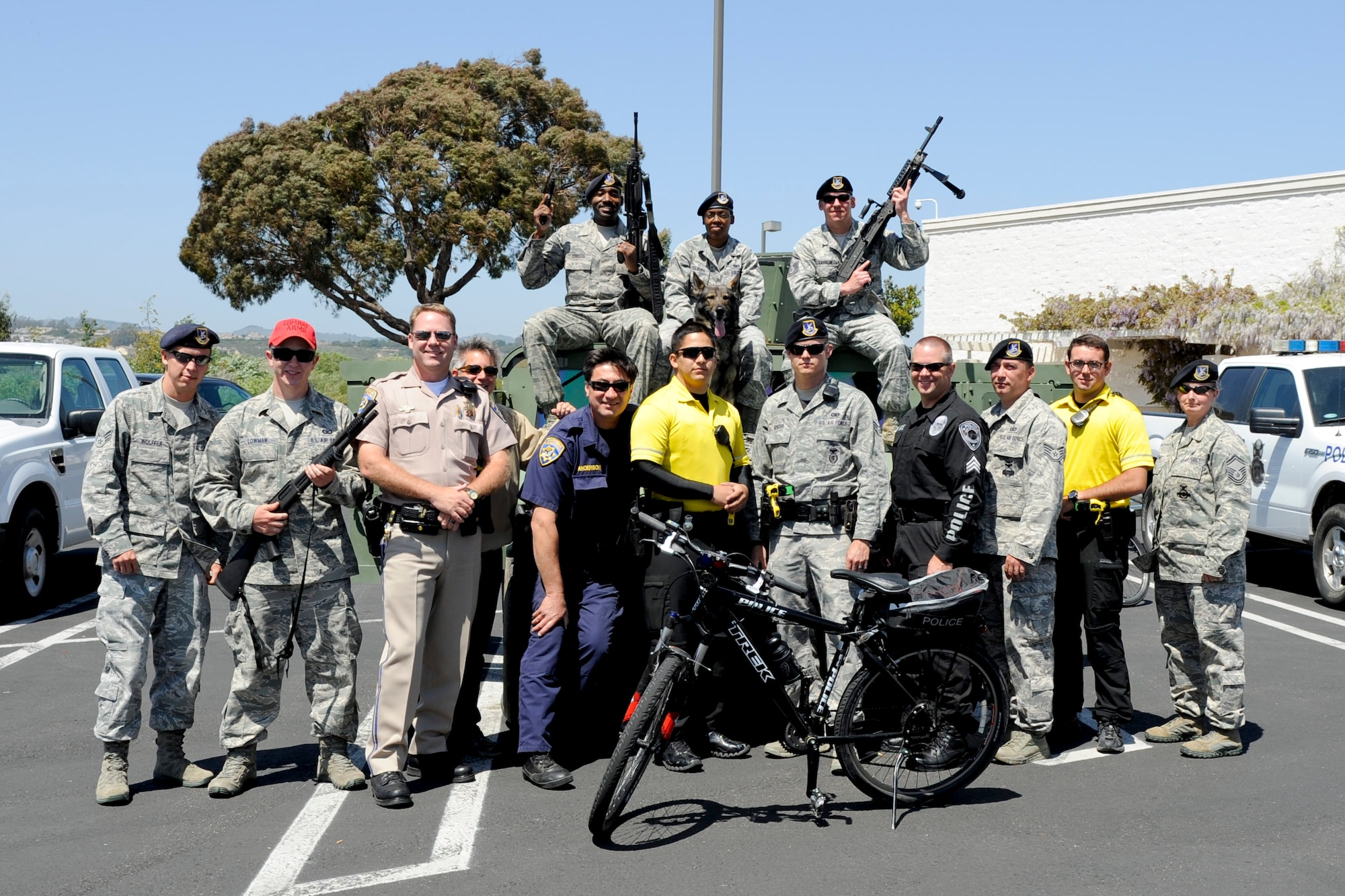VANDENBERG AIR FORCE BASE, Calif. -- 30th Security Forces Squadron members and local law enforcment official pose for a group photo during a police display event at the Albertsons parking lot in Lompoc, Wednesday, May 16th, 2012. The display was held in conjunction with National Police Week, an annual celebration that recognizes the service and sacrifice of U.S. law enforcement personnel. (U.S. Air Force photo/Staff Sgt. Levi Riendeau)