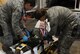 WHITEMAN AIR FORCE BASE, Mo. -- Members of the medical group simulate strapping a child in a stretcher during the “tent city” portion of Operation Spirit at the Deployment Center April 21. After a morning of deploying the participants visited “tent city” where they viewed equipment and viewed demonstrations from different base agencies to include explosive ordinance disposal, security forces, fire department and medical group. (U.S. Air Force photo/Airman 1st Class Bryan Crane)(Released)