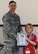 WHITEMAN AIR FORCE BASE, Mo. --  A child receives an award after returning home from her “deployment” during Operation Spirit April 21. After the award ceremony children were served lunch by the USO and visited “tent city” where they viewed equipment and were shown demonstrations from different base agencies to include explosive ordinance disposal, security forces, fire department and medical group. (U.S. Air Force photo/Airman 1st Class Bryan Crane)(Released)
