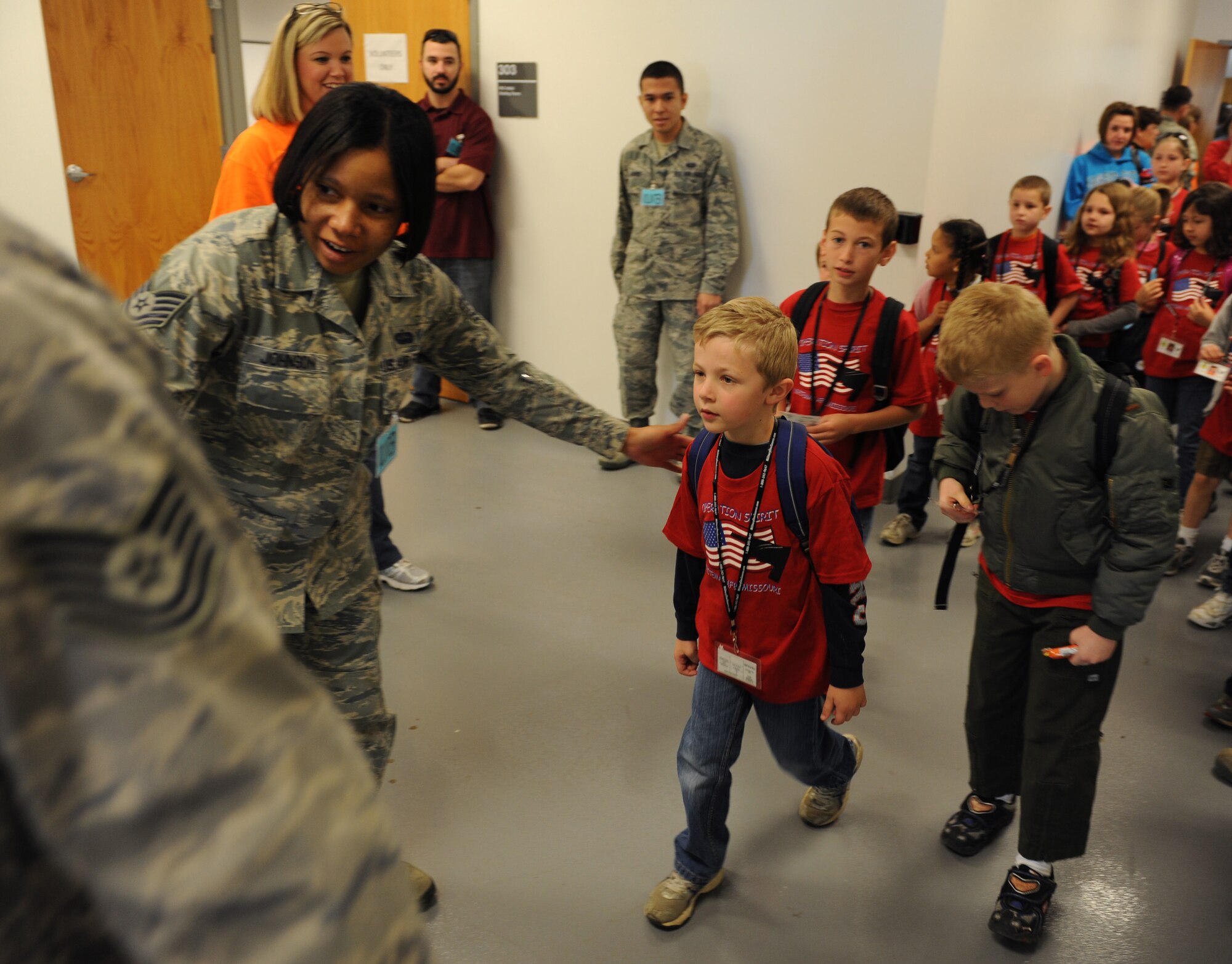 WHITEMAN AIR FORCE BASE, Mo. -- Children from Operation Spirit head to the deployment line to turn in their mock power of attorney paper, receive dog tags and receive guidance from the Whiteman Chapel at the Deployment Center April 21. Operation Spirit is held annually to help children experience a “deployment” in a way they understand. (U.S. Air Force photo/Airman 1st Class Bryan Crane)(Released)