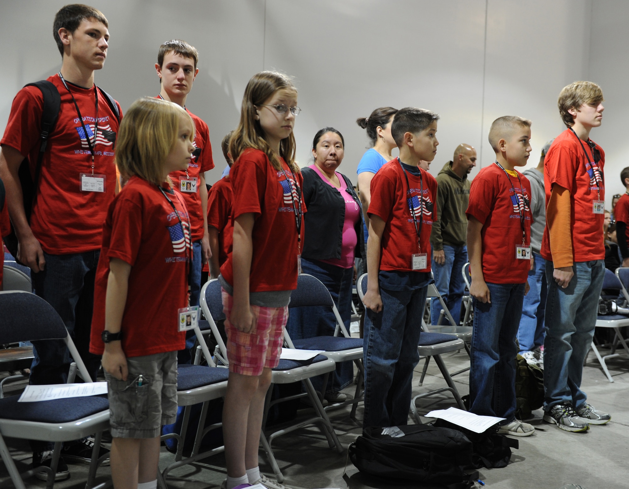 WHITEMAN AIR FORCE BASE, Mo. -- Children practice standing at attention during Operation Spirit at the Deployment Center April 21. Children were taught military customs and courtesies during the mock deployment. (U.S. Air Force photo/Airman 1st Class Bryan Crane)(Released)