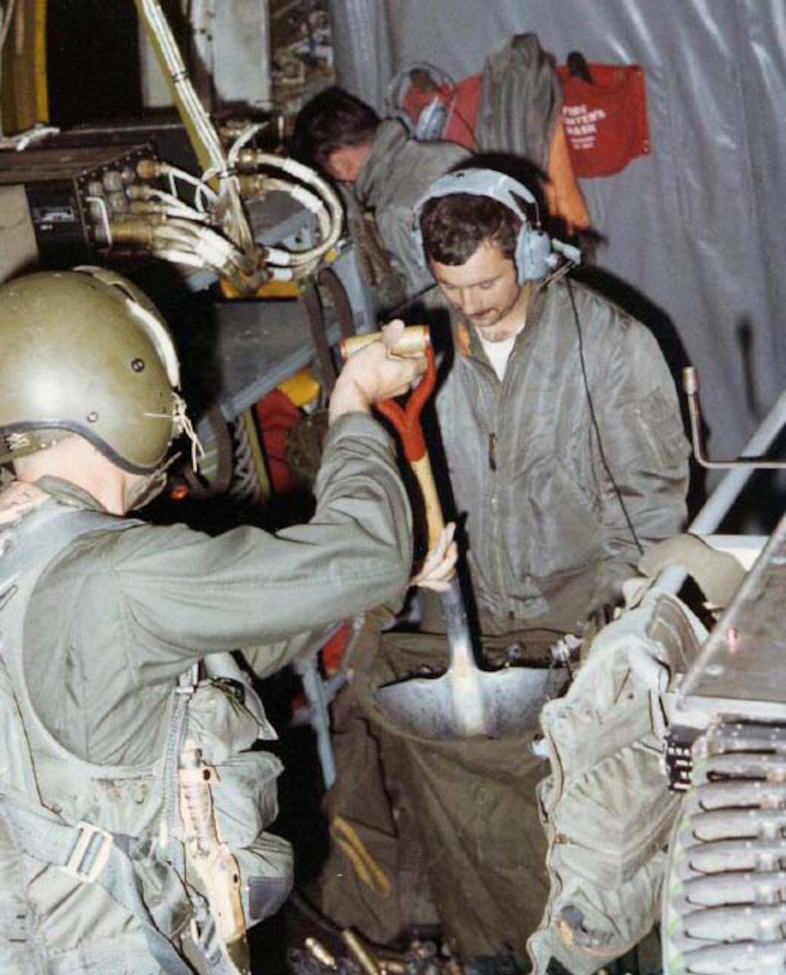 When the AC-130’s 20mm guns fired, hundreds of empty casings fell to the floor. Gunners shoveled them into bags, as pictured here. (U.S. Air Force photo)