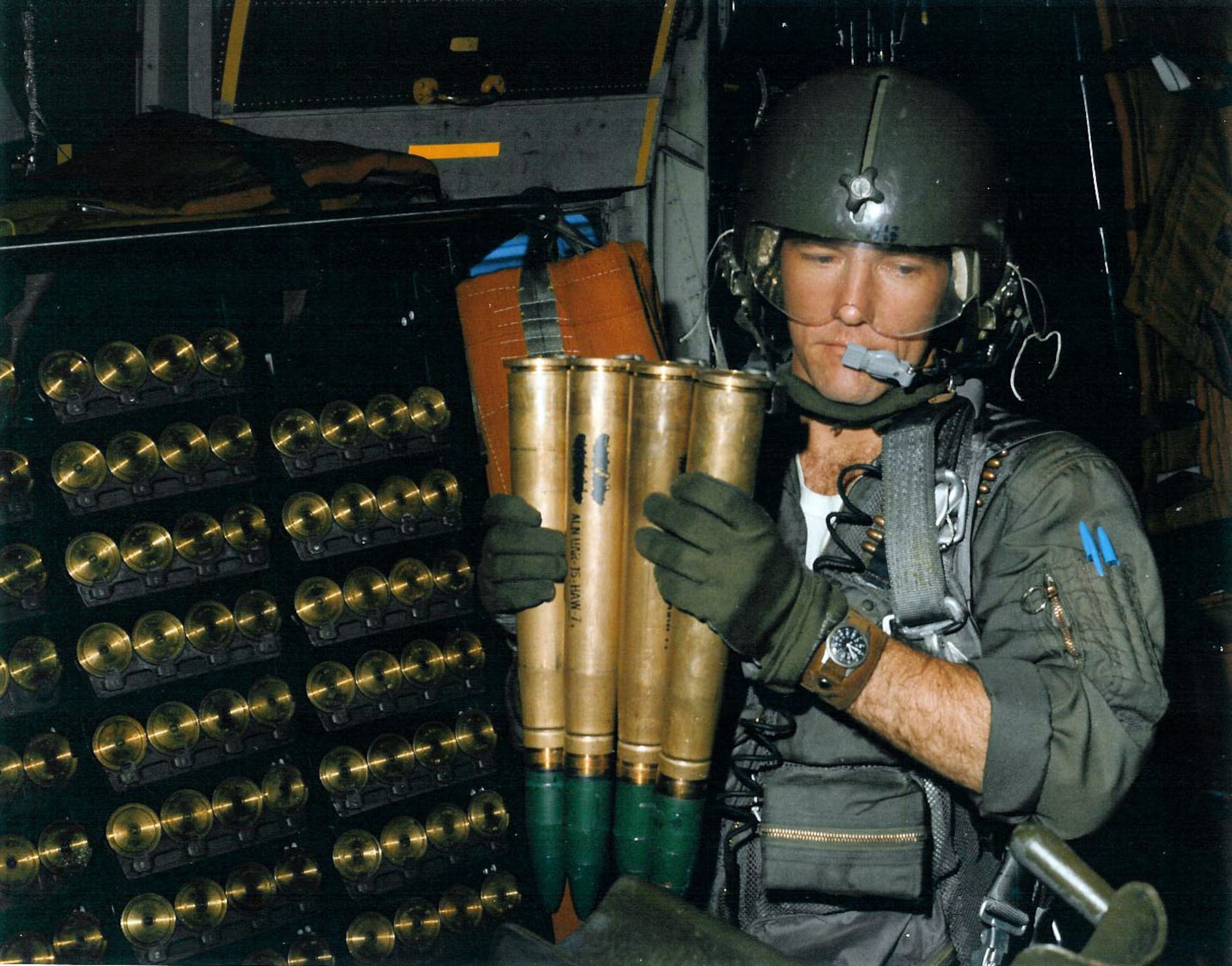 AC-130 gunner Sgt. Donald Dawson pulls out a four-round 40mm clip from the onboard storage rack. (U.S. Air Force photo)
