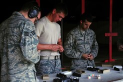 Military members out of Joint Base Charleston, S.C., load the M-9, May16, 2012. The shooting competition is for national police week but its open to all military members, and civilians on base. (U.S. Air Force photo/Airman 1st Class Chacarra Walker)