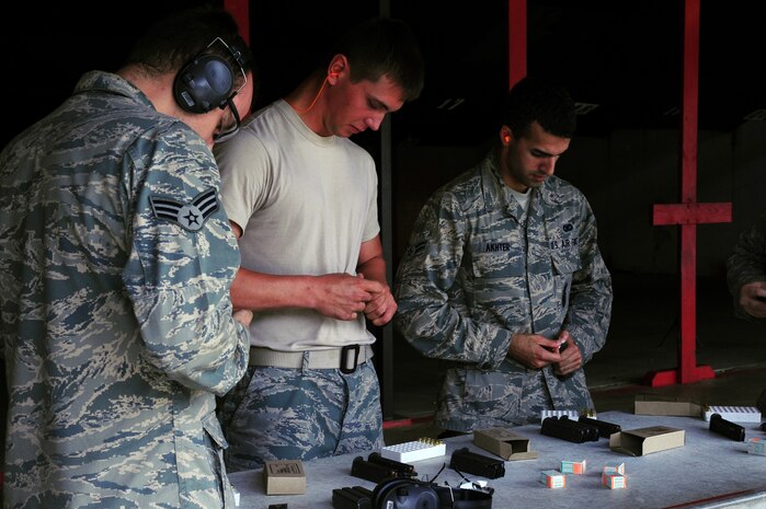 Military members out of Joint Base Charleston, S.C., load the M-9, May16, 2012. The shooting competition is for national police week but its open to all military members, and civilians on base.  (U.S. Air Force photo/ Airman 1st Class Chacarra Walker)