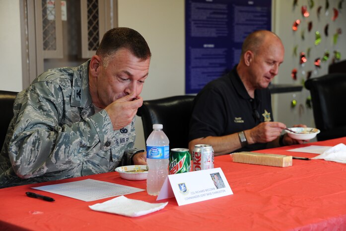 Col. Richard McComb, Joint Base Charleston Commander, and Al Cannon, Sheriff of Charleston County, were judges at the 628th Security Forces Squadron Chili Cook Off, May 15 at Joint Base Charleston - Air Base. This event was part of National Police Week, which occurs annually during the week of May 15, recognizing the service and sacrifice of U.S. law enforcement personnel. (U.S. Air Force photo/Airman 1st Class Ashlee Galloway)