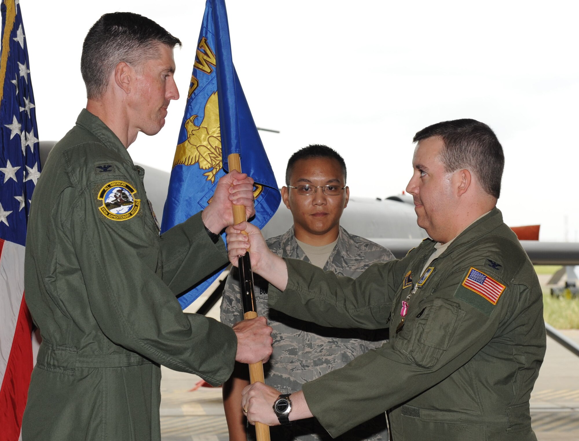 Col. Chris Craige, 39th Air Base Wing commander, left, receives the guidon from Col. Eric Casler, 39th Expeditionary Operations Group commander, during a change-of-command ceremony May 14, 2012, at Incirlik Air Base, Turkey. Casler relinquished command of the 39th EOG to Col. Dana Hessheimer. (U.S. Air Force photo by Senior Airman Anthony Sanchelli/Released)
