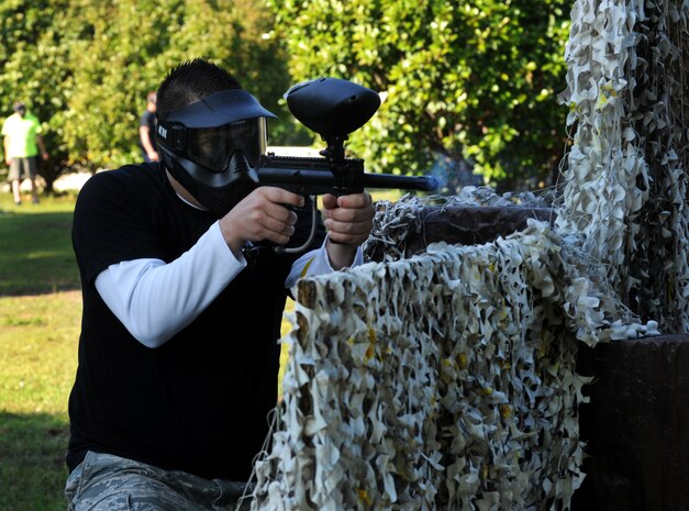 Airman 1st Class Joshua Cook, 628th Security Forces Squadron police officer, shoots a paintball during a match against defenders from the 628th Civil Engineer Squadron during the "Guns and Hoses" fitness challenge, May 15 at Joint Base Charleston - Air Base, S.C. The 628th SFS hosted the firefighters in a day full of competition known as the "Guns and Hoses" fitness challenge. The competitions included a paintball match, defender ball and a softball game. The event kicked off National Police Week, which occurs annually during the week of May 15. National Police Week recognizes the service and sacrifice of U.S. law enforcement personnel. (U.S. Air Force photo/Airman 1st Class Ashlee Galloway)