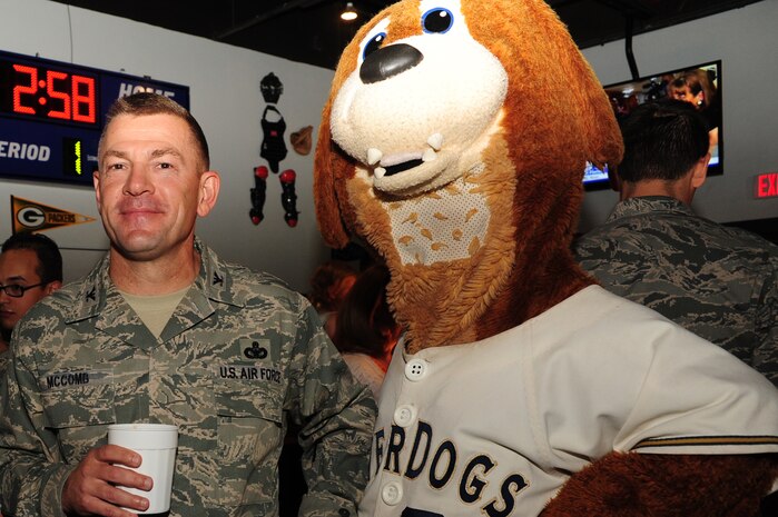 Col. Richard McComb, Joint Base Charleston Commander, poses for a picture with Charlie T River dog during the Grand Opening of Rookies Sports Grill at Joint Base Charleston May 11, 2012. Charlie was the first overall selection and first high school mascot in the June 1994 Minor League Mascot Draft. (U.S. Air Force photo/Airman 1st Class Chacarra Walker)