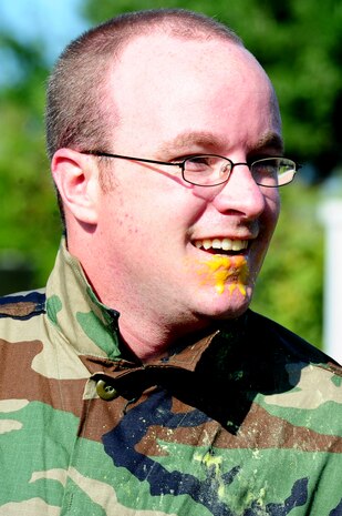 Senior Airman Craig Burnett, 628th Civil Engineer Squadron firefighter, shows off the paint on his face after a paintball match against defenders from the 628th Security Forces Squadron during the "Guns and Hoses" fitness challenge, May 15 at Joint Base Charleston - Air Base, S.C.  The 628th SFS hosted the firefighters in a day full of competition known as the "Guns and Hoses" fitness challenge.  The competition included a paintball match, defender ball and a softball game.  The event kicked off National Police Week, which occurs annually during the week of May 15.  It recognizes the service and sacrifice of U.S. law enforcement personnel.  (U.S. Air Force photo/ Staff Sgt. Nicole Mickle)  
 
