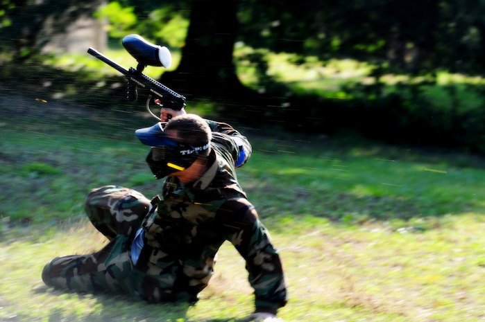 Airman 1st Class Andrew Bradley, 628th Civil Engineer Squadron firefighter, slides behind a barrier during a paintball match against defenders from the 628th Security Forces Squadron during the "Guns and Hoses" fitness challenge, May 15 at Joint Base Charleston - Air Base, S.C.  The 628th SFS hosted the firefighters in a day full of competition known as the "Guns and Hoses" fitness challenge.  The competition included a paintball match, defender ball and a softball game.  The event kicked off National Police Week, which occurs annually during the week of May 15.  It recognizes the service and sacrifice of U.S. law enforcement personnel.  (U.S. Air Force photo/ Staff Sgt. Nicole Mickle)  