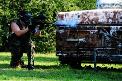 Staff Sgt. John Fredrickson, 628th Civil Engineer Squadron firefighter, takes cover behind a trailer during a match against defenders from the 628th Security Forces Squadron during the "Guns and Hoses" fitness challenge, May 15, 2012 at Joint Base Charleston, S.C. The 628th SFS hosted the firefighters in a day full of competition known as the "Guns and Hoses" fitness challenge. The competition included a paintball match, defender ball and a softball game. The event kicked off National Police Week, which occurs annually during the week of May 15. It recognizes the service and sacrifice of U.S. law enforcement personnel. (U.S. Air Force photo/Staff Sgt. Nicole Mickle)