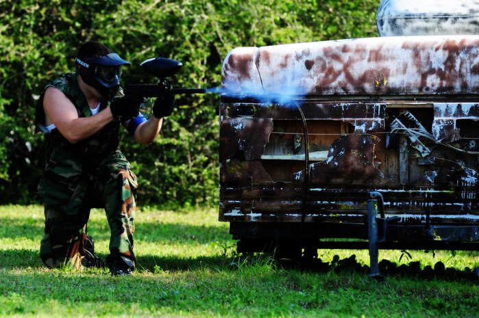 Staff Sgt. John Fredrickson, 628th Civil Engineer Squadron firefighter, takes cover behind a trailer during a match against defenders from the 628th Security Forces Squadron during the "Guns and Hoses" fitness challenge, May 15 at Joint Base Charleston - Air Base, S.C.  The 628th SFS hosted the firefighters in a day full of competition known as the "Guns and Hoses" fitness challenge.  The competition included a paintball match, defender ball and a softball game.  The event kicked off National Police Week, which occurs annually during the week of May 15.  It recognizes the service and sacrifice of U.S. law enforcement personnel.  (U.S. Air Force photo/ Staff Sgt. Nicole Mickle)  