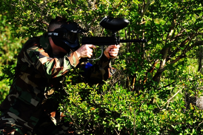 Airman 1st Class Andrew Bradley , 628th Civil Engineer Squadron firefighter, fires his paintball gun during a  match against defenders from the 628th Security Forces Squadron during the "Guns and Hoses" fitness challenge, May 15 at Joint Base Charleston - Air Base, S.C.  The 628th SFS hosted the firefighters in a day full of competition known as the "Guns and Hoses" fitness challenge.  The competition included a paintball match, defender ball and a softball game.  The event kicked off National Police Week, which occurs annually during the week of May 15.  It recognizes the service and sacrifice of U.S. law enforcement personnel.  (U.S. Air Force photo/ Staff Sgt. Nicole Mickle)  